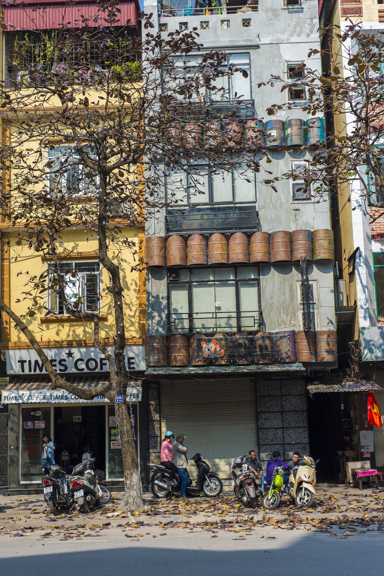 A street shot of Hanoi, Vietnam looking at buildings.