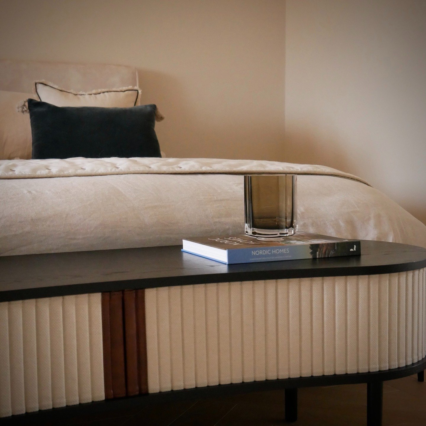 A quiet expression of luxury lies in simplicity. At the foot of the bed, this Umage bench embodies the essence of refined Scandinavian design, clean lines, natural oak and softly tailored upholstery. Styled by Lou Joia Studio.