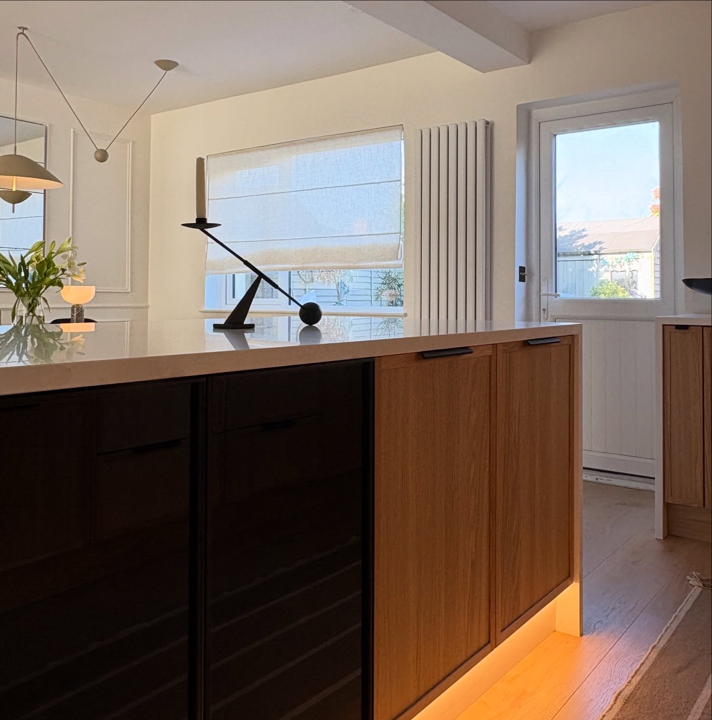 Lou Joia crafted a unique Penninsula in this kitchen, drawing inspiration from my Ethnicraft Anders buffet. Smoked glass doors illuminate at night and oak cabinets provide extra storage with LED lighting. Next week, we will reveal more information on