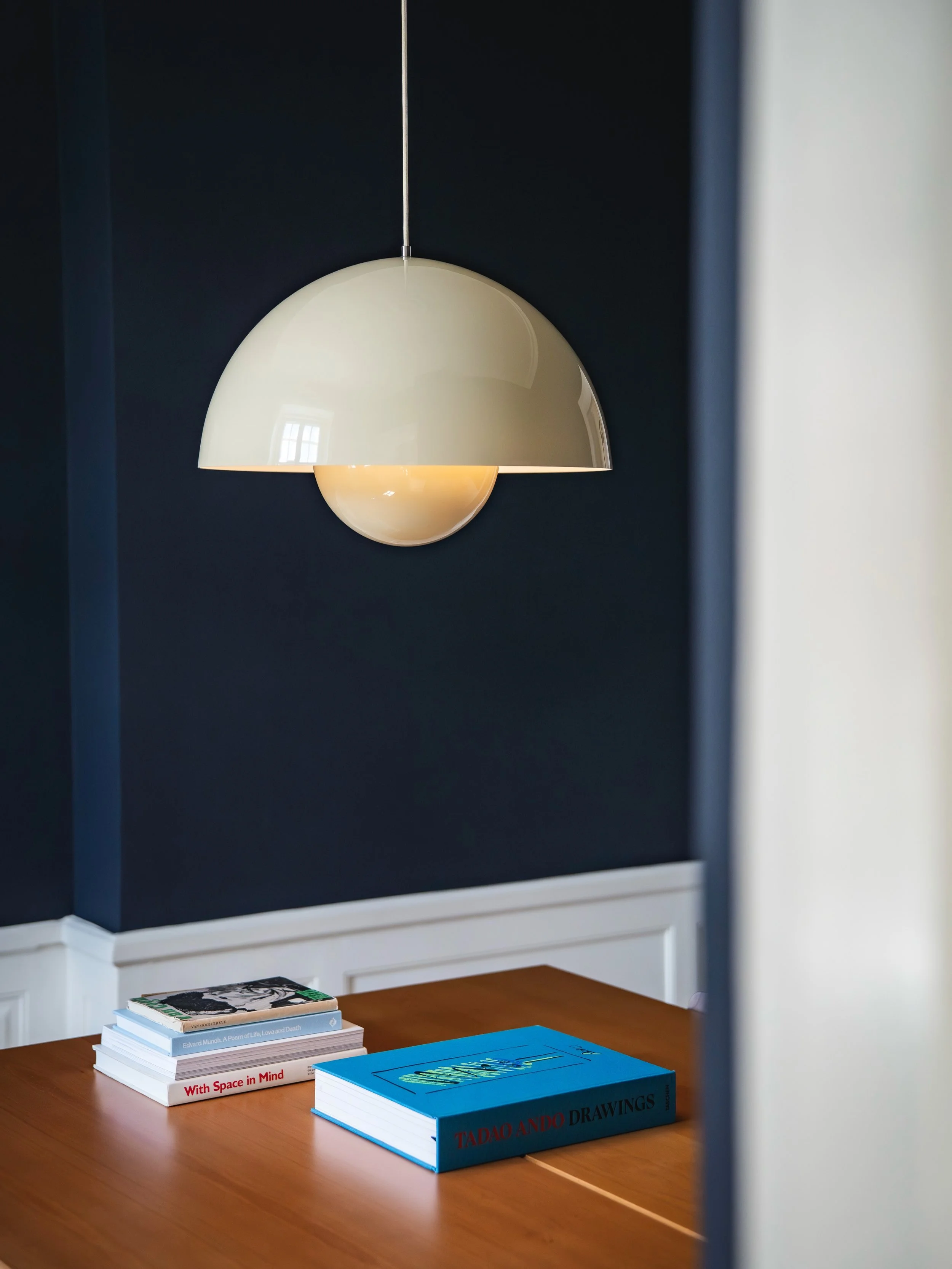 A study in contrast. Deep blue walls, warm timber and sculptural light come together in a composition that feels both restrained and expressive. A photo by @eddierunswild with Lou Joia Studio. #light #scandinaviandesign #interiordesign