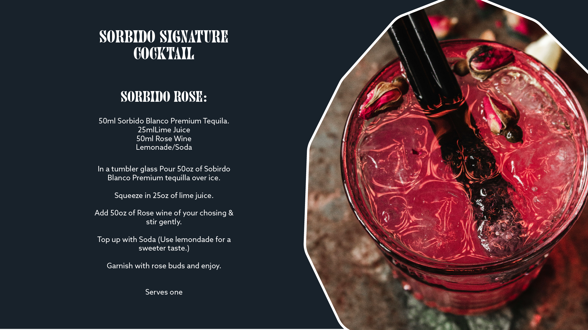 A close-up image of a red cocktail in a glass, garnished with dried rose buds and flowers, with a black straw. The cocktail is on a textured surface, likely a wooden table.