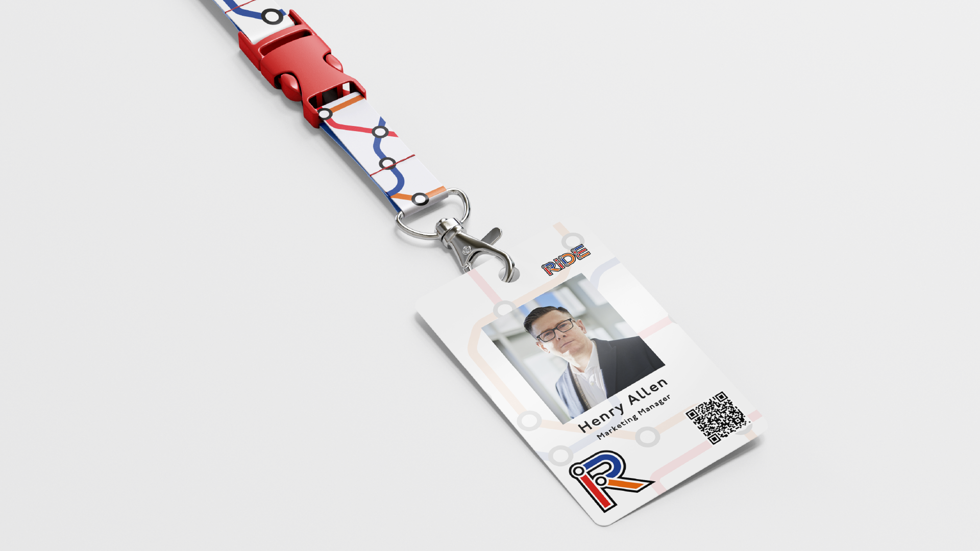 ID badge with photo of a man in a suit, text 'Henry Allen', title 'Marketing Manager', a QR code, and a lanyard featuring a map and transportation symbols.