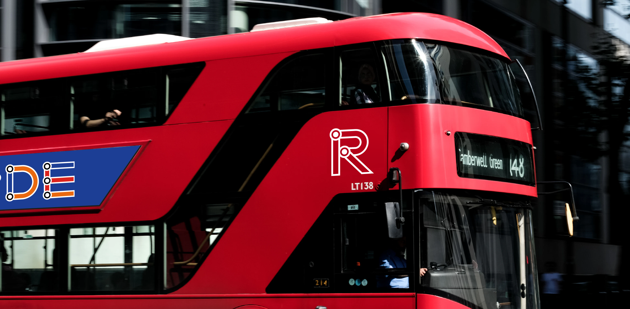 Red double-decker bus with route number 148 and destination Amberwell Green, passing through an city street with modern buildings.