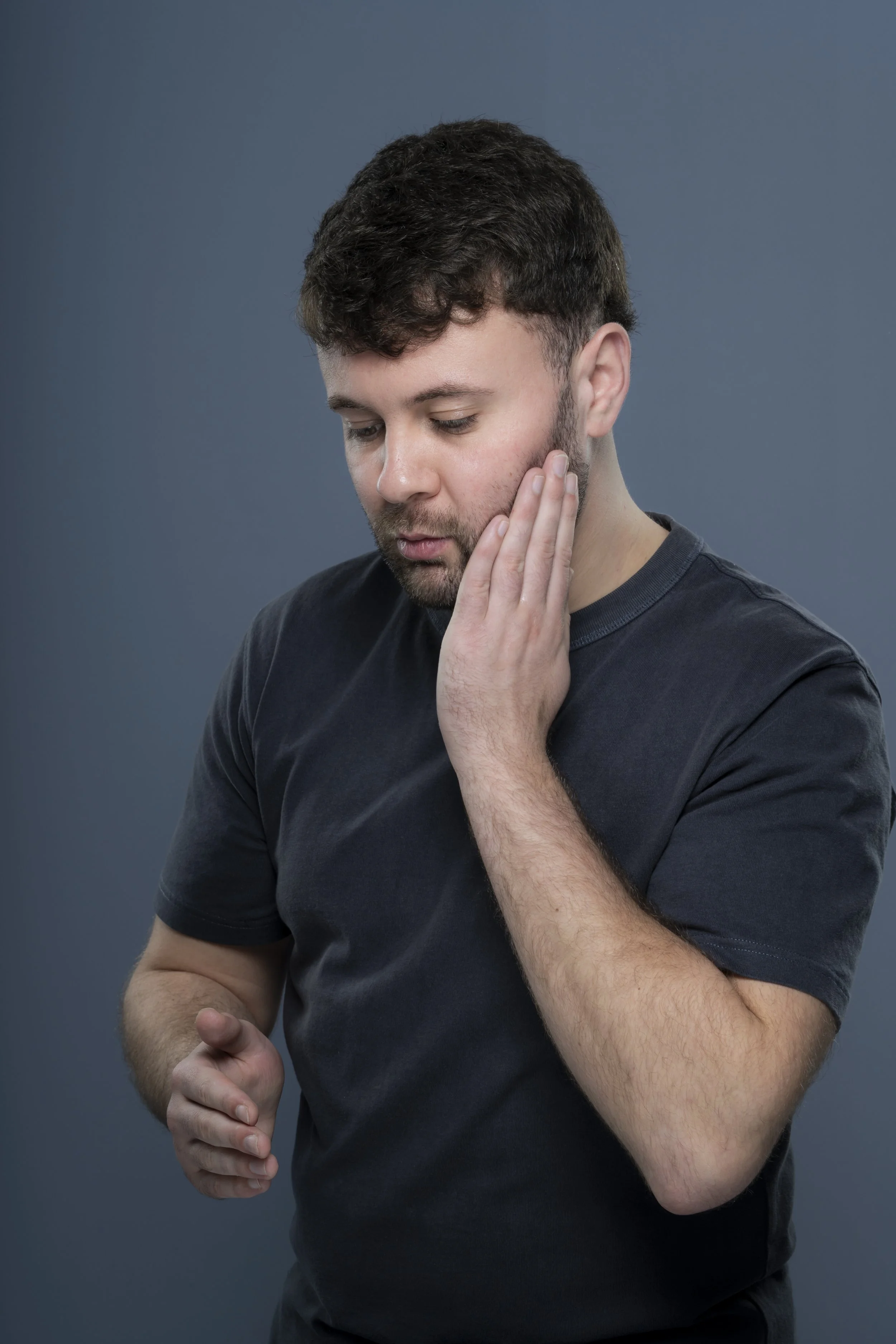model applying Brownbull beard & body oil to face