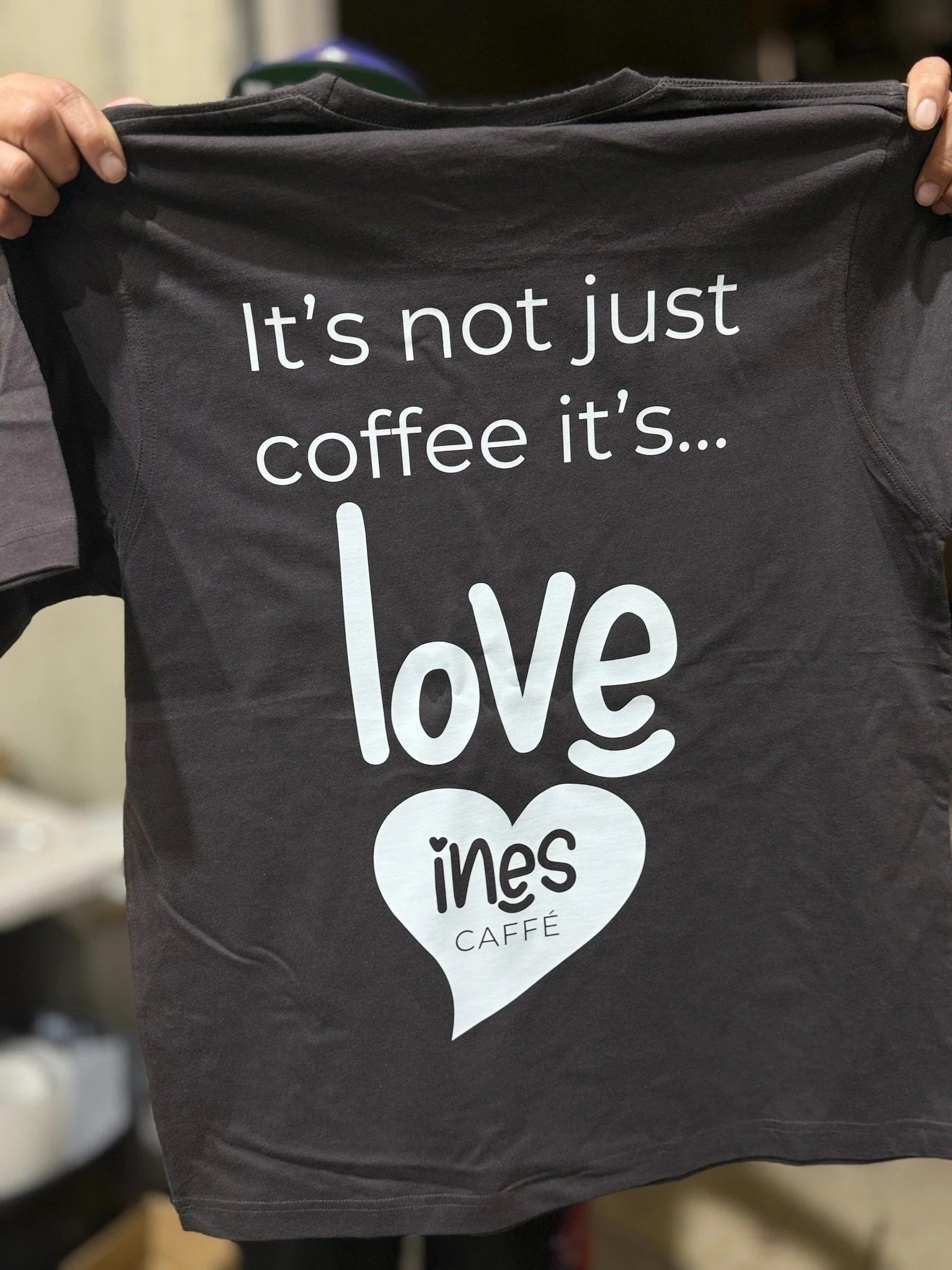 Custom printed cafe uniform t-shirt for Ines Cafe Sydney showing white logo print on black shirt