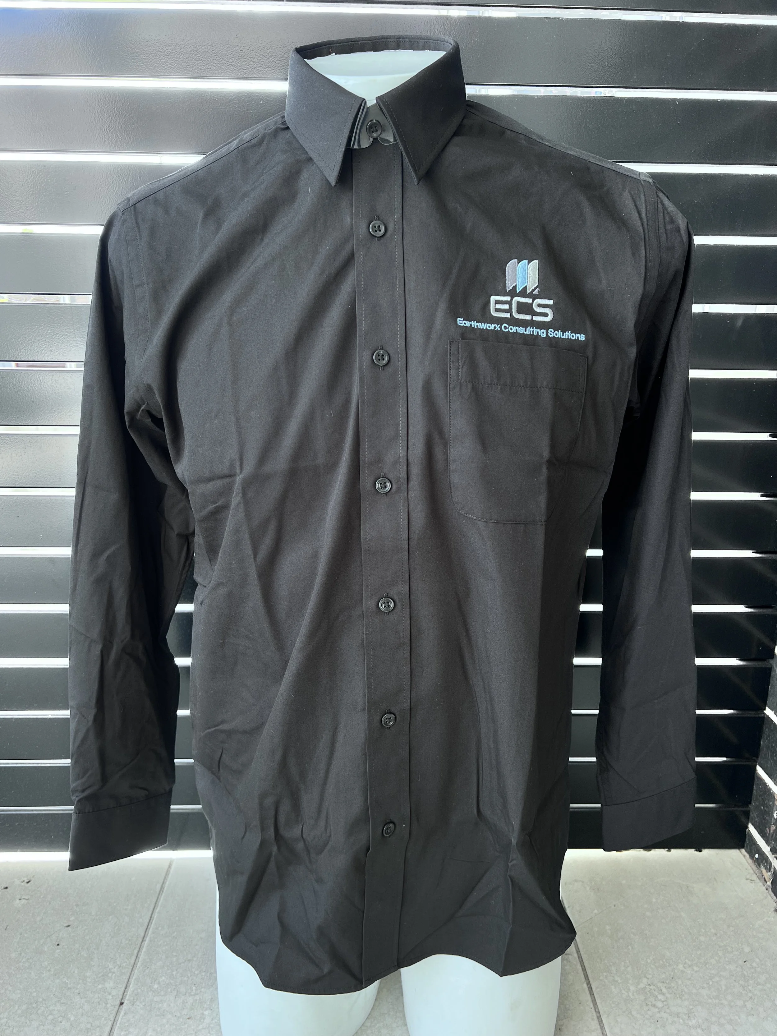 Black long-sleeve button-up shirt with embroidery of the Earthworm Consulting Solutions logo on the left chest pocket.
