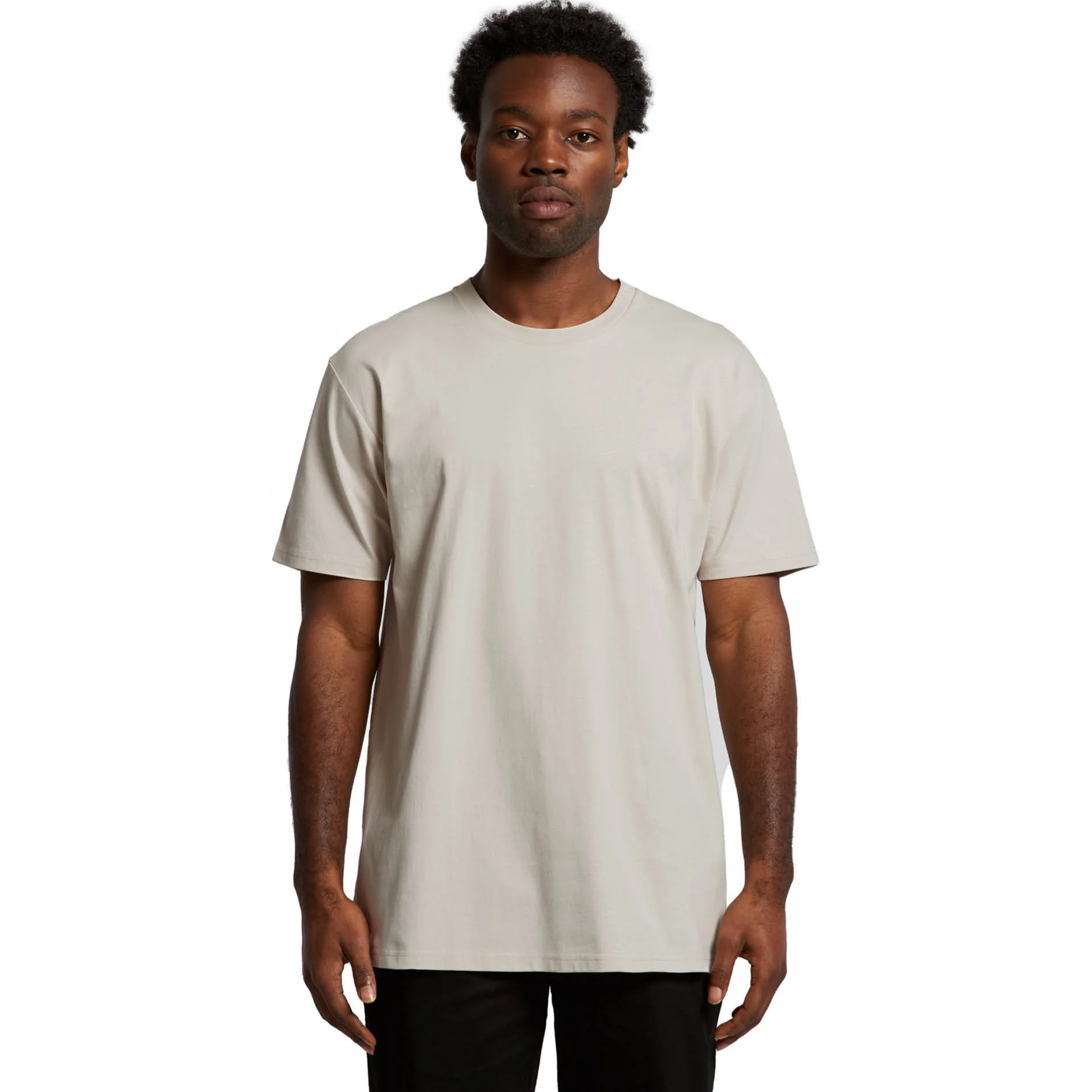 A man wearing a beige t-shirt standing against a white background.
