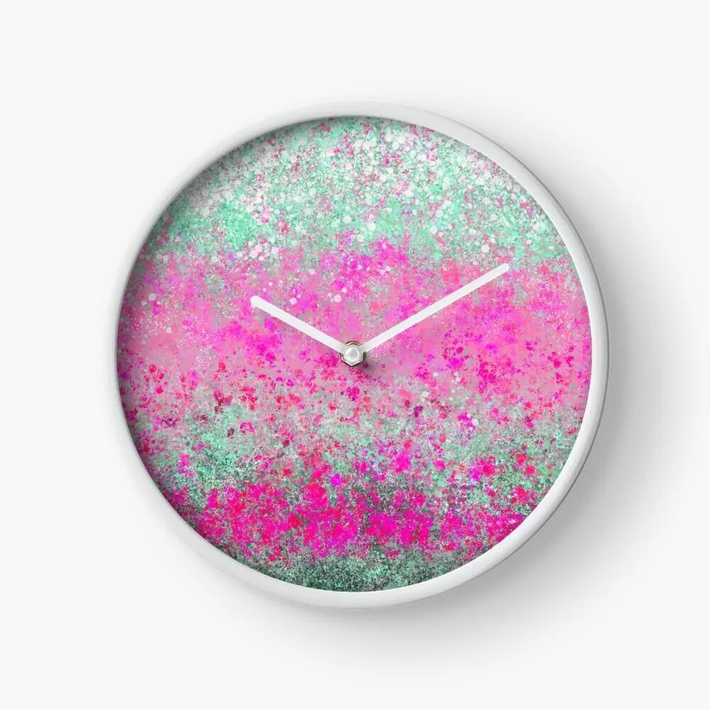 Round wall clock with a colorful pink, green, and white speckled abstract background and white frame.