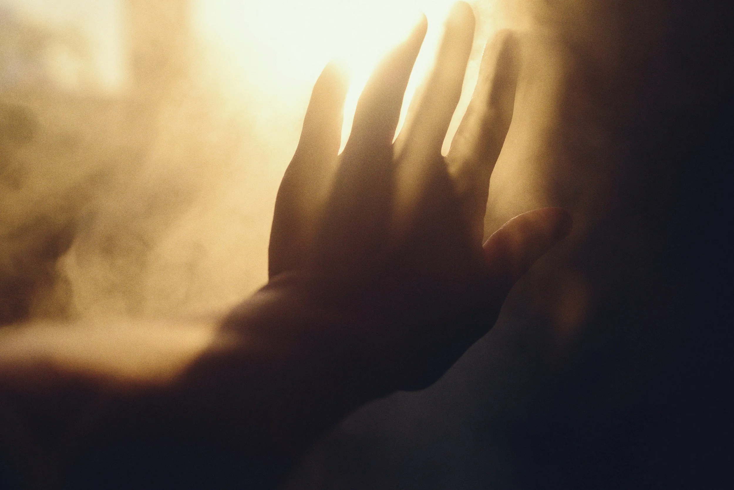 A gentle silhouette of a hand reaching out, symbolising the supportive presence of your soul family and the comforting, ever-present guidance from the spirit world.