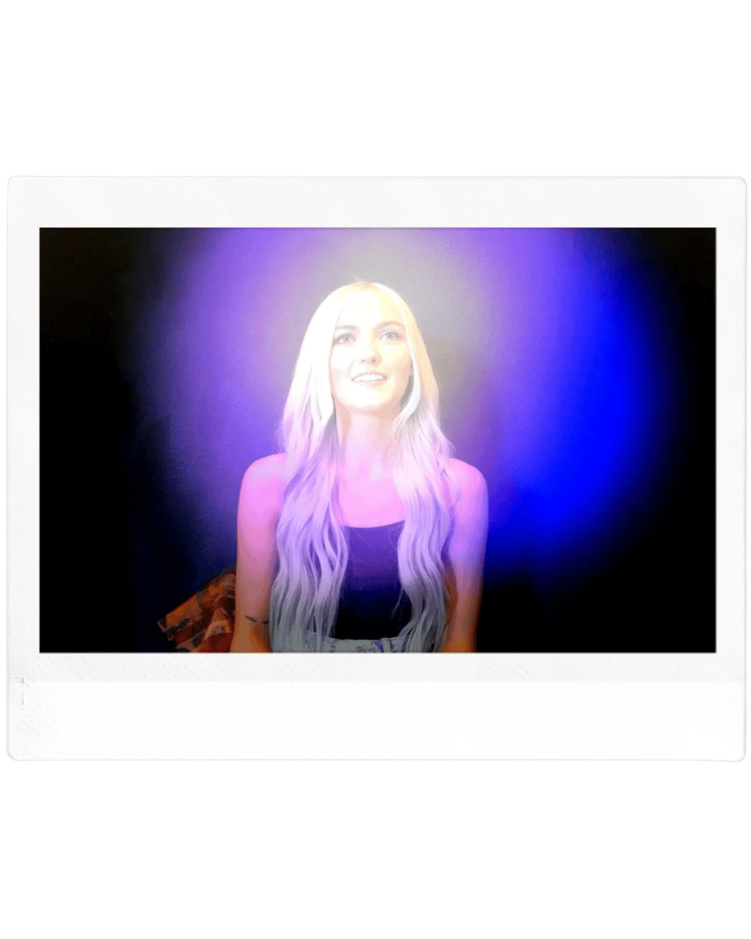 Polaroid photo of a young woman with long blonde hair, sitting against a dark background with purple and blue lighting effects.