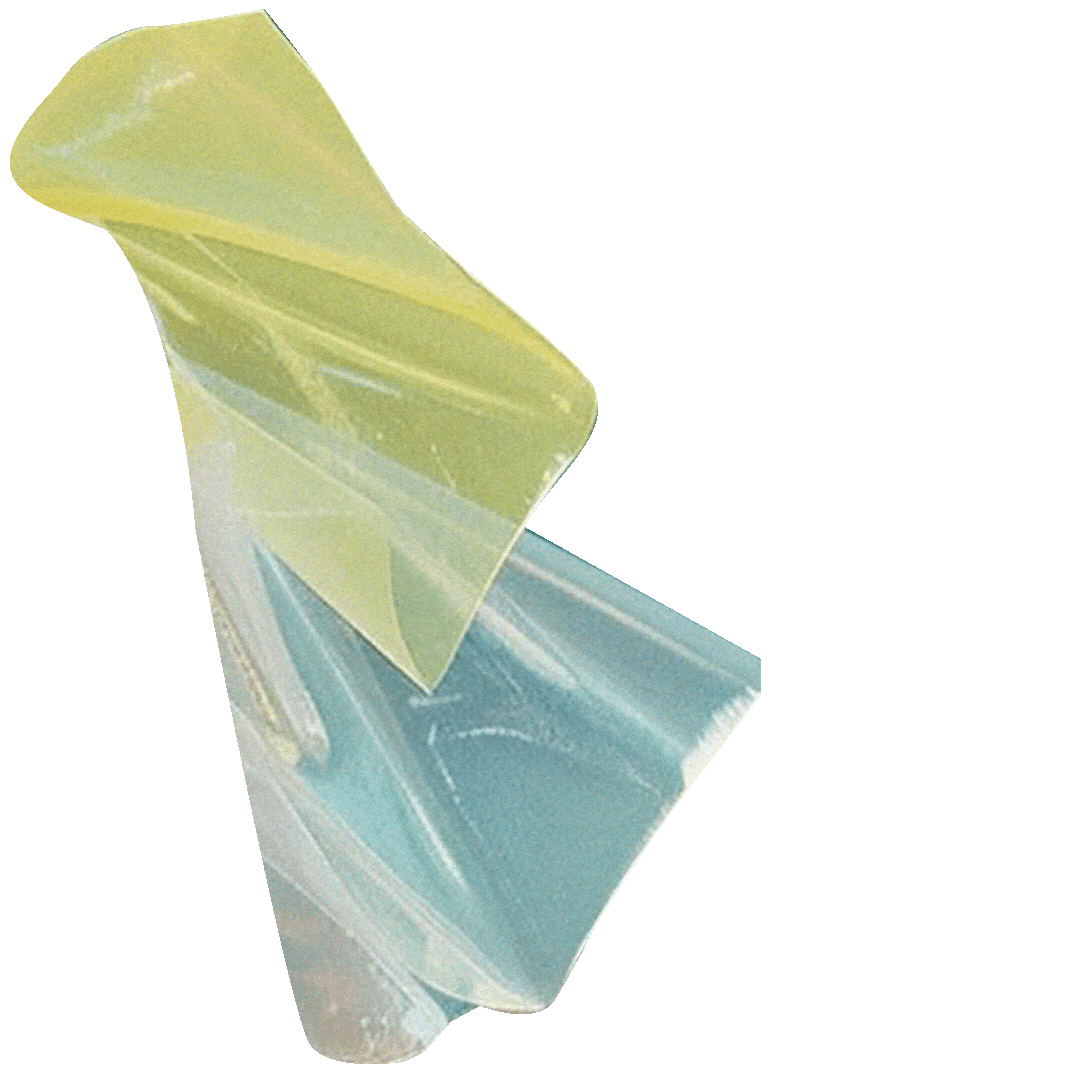 Close-up of a pastel-colored, semi-transparent plastic or cellophane wrapper with a shiny, reflective surface, partially unwrapped.