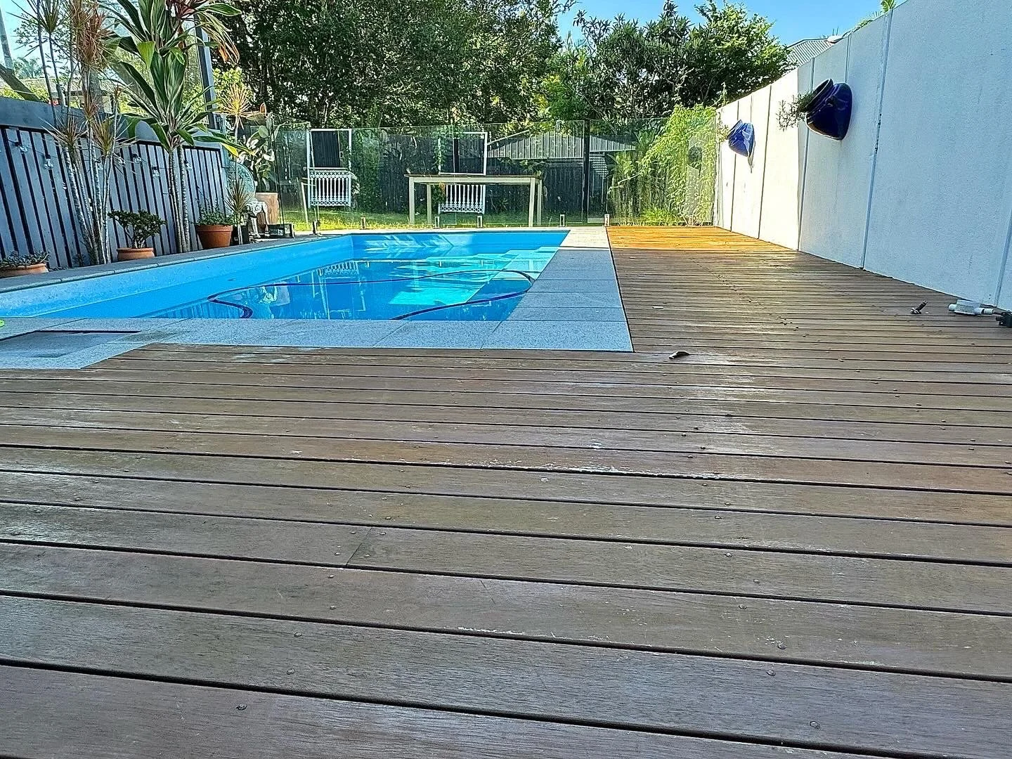 Grey, worn pool deck before any work, with the old coating worn through