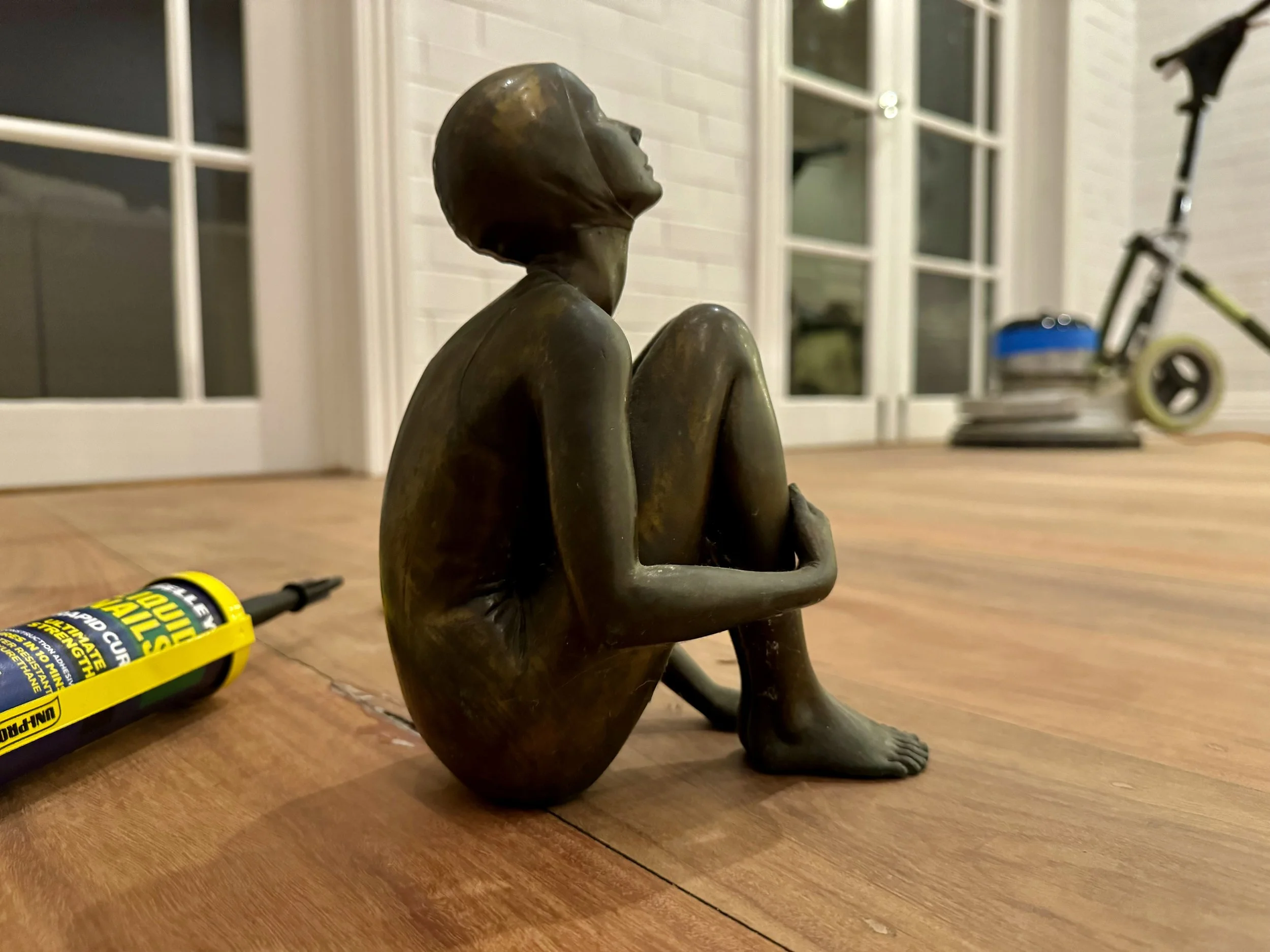 Bronze sculpture displayed on a restored timber floor in a Brisbane home, showcasing the polished finish by Dyna Floors.