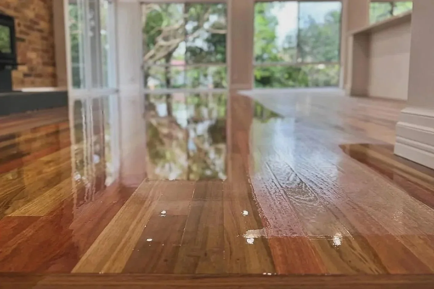 Freshly sanded and polished timber floor in a Brisbane home with a smooth, high-gloss finish reflecting natural light.