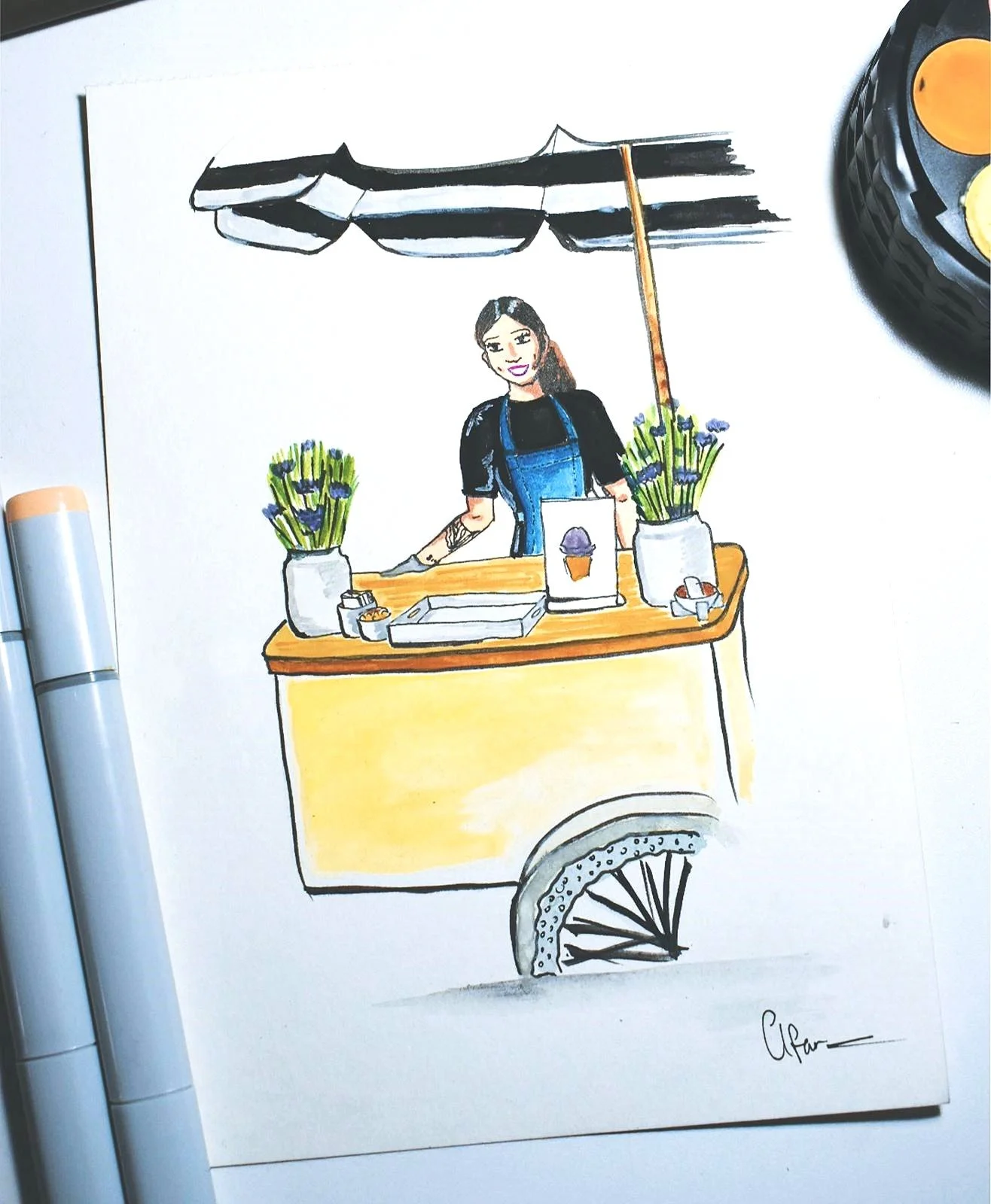 A colorful hand-drawn illustration of a woman standing at a small ice cream stand with a black and white striped umbrella, two potted plants with purple flowers, and a cone sign. The stand is yellow with a wheel at the bottom.
