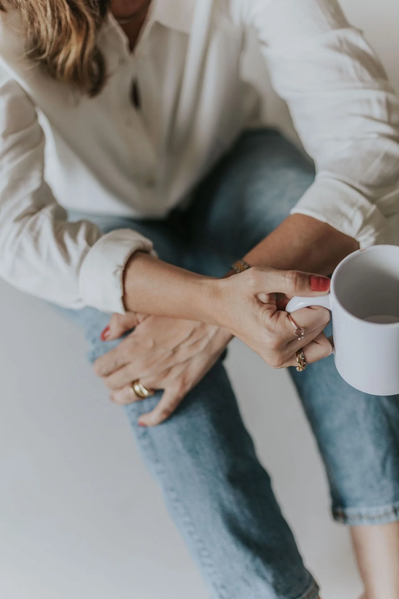 woman's hands holding coffee cup