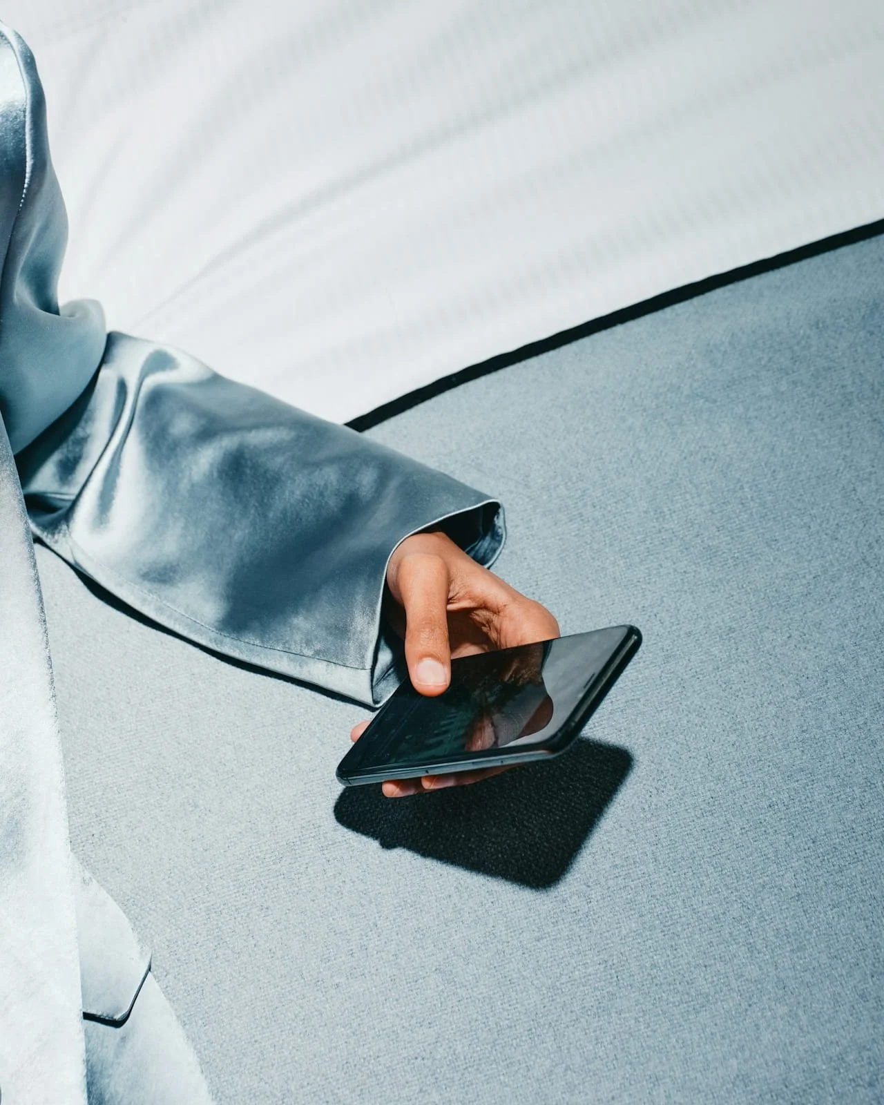 woman in blue blazer holding phone