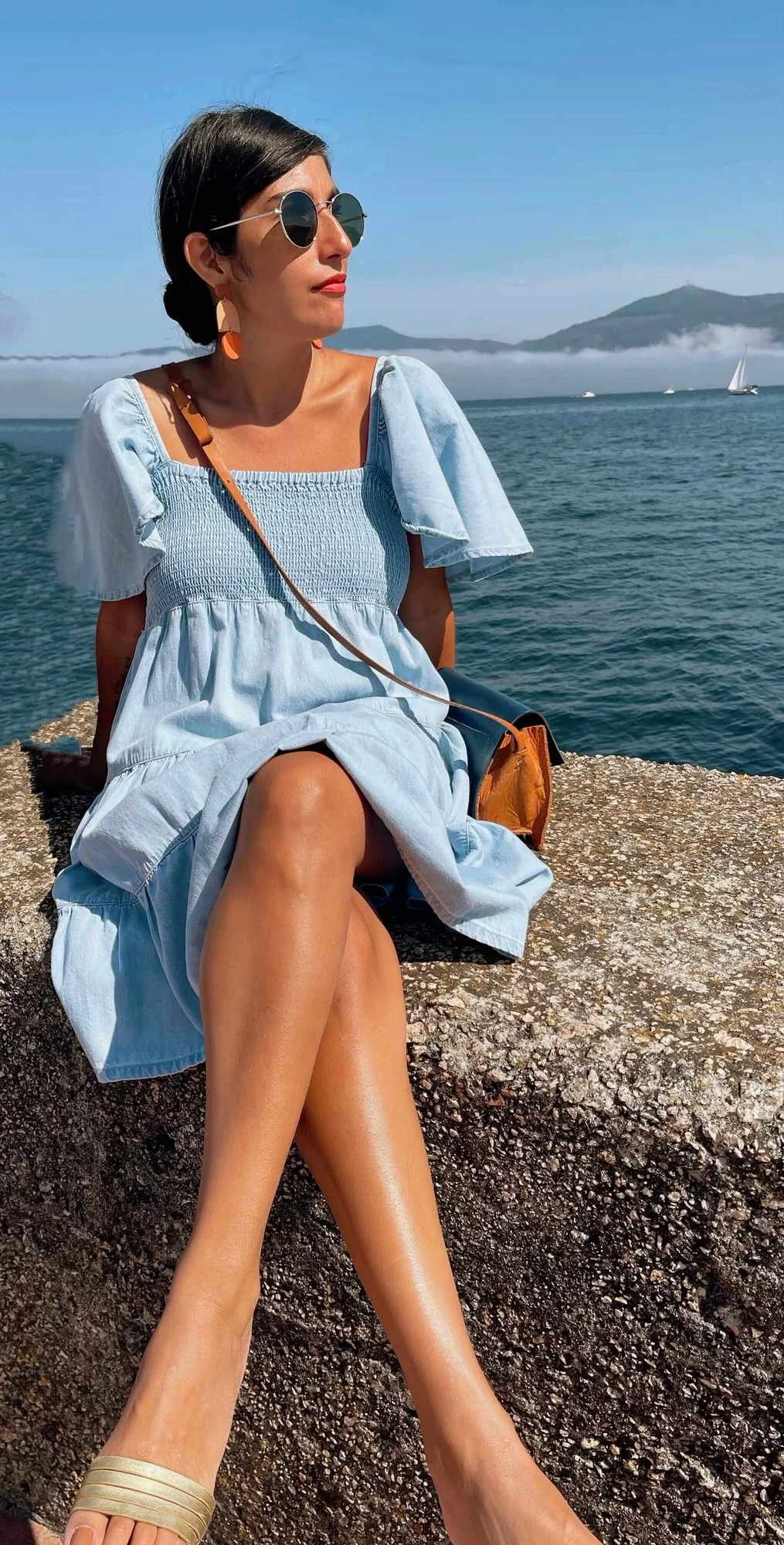 Elizabeth Quintal Squarespace & Shopify Web Designer & Developer sitting near the ocean in a blue dress