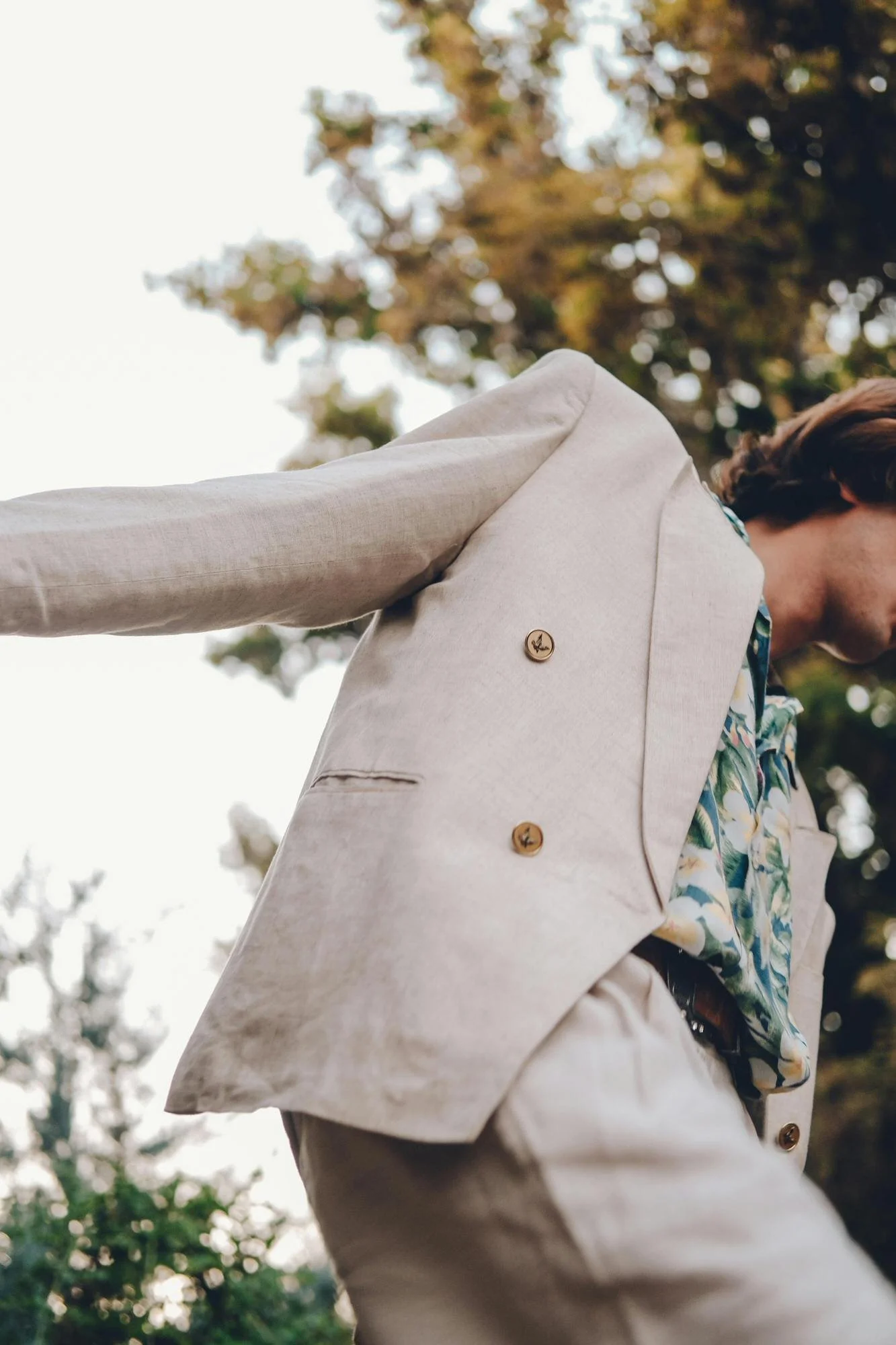 website design and seo for therapist. person in cream suit with patterned shirt dancing outside