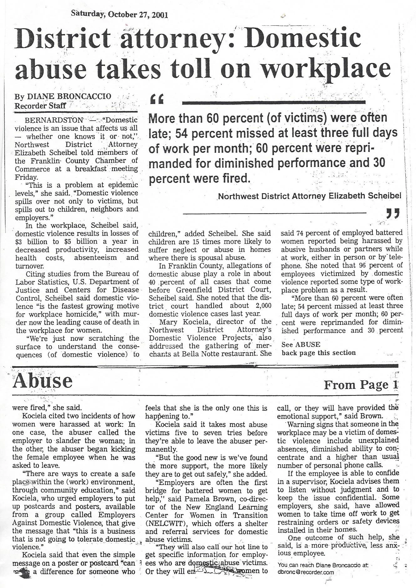 Newspaper article titled "District attorney: Domestic abuse takes toll on workplace," published on October 27, 2001. The article discusses domestic violence, its impact on workplaces, victim statistics, and efforts by the Northwest District Attorney'