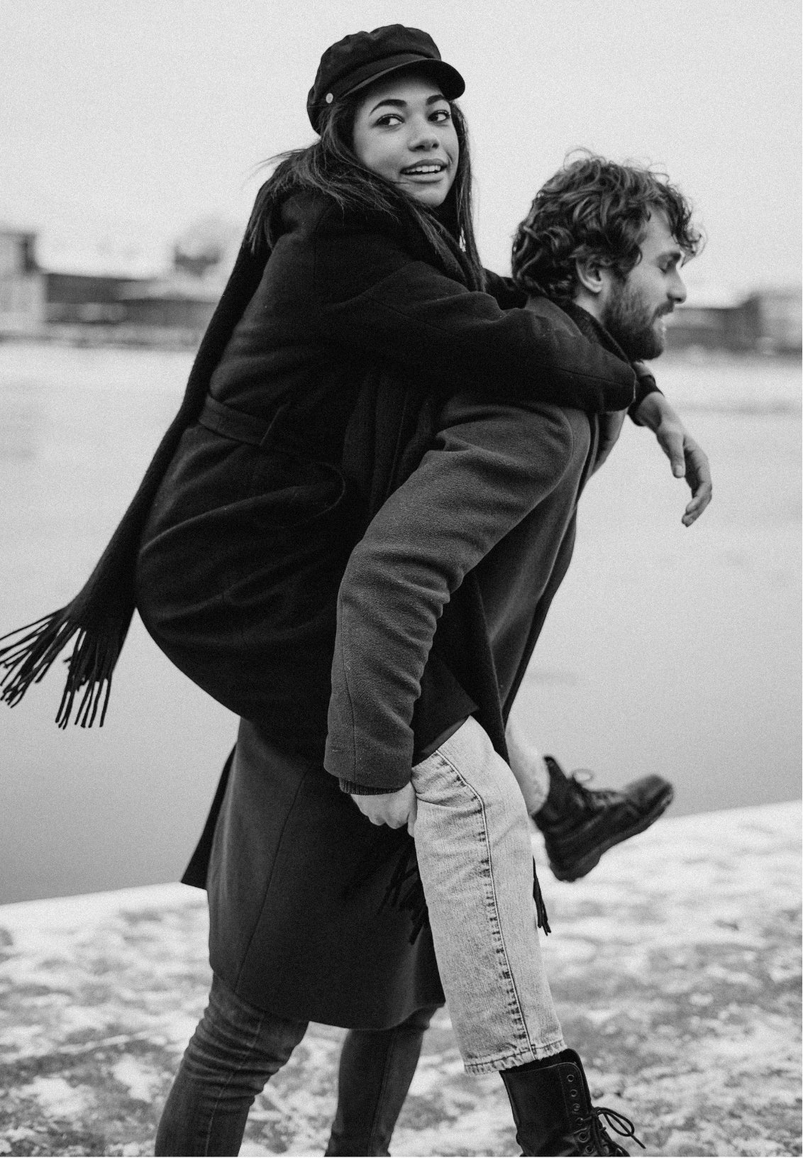 A man is giving a piggyback ride to a woman, symbolizing a connected and happy relationship following couples counseling sessions