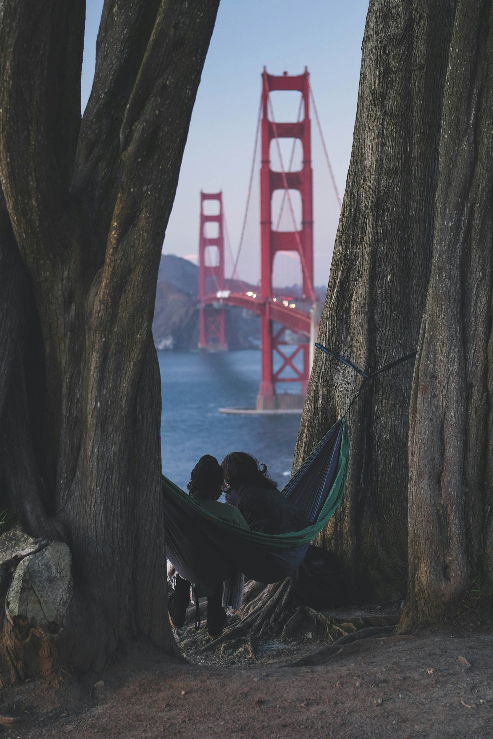 A couple laying in a hammock, overlooking the Golden Gate Bridge, symbolizing relationship counseling in San Francisco