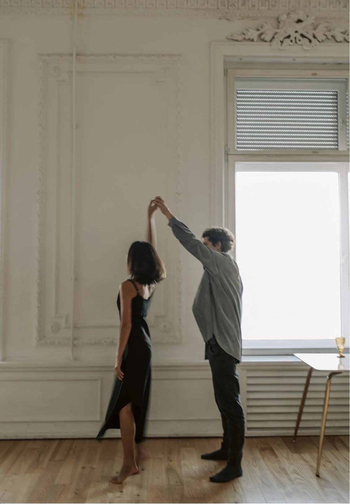 a couple dancing indoors, representing a good relationship that FL couples therapy can help foster