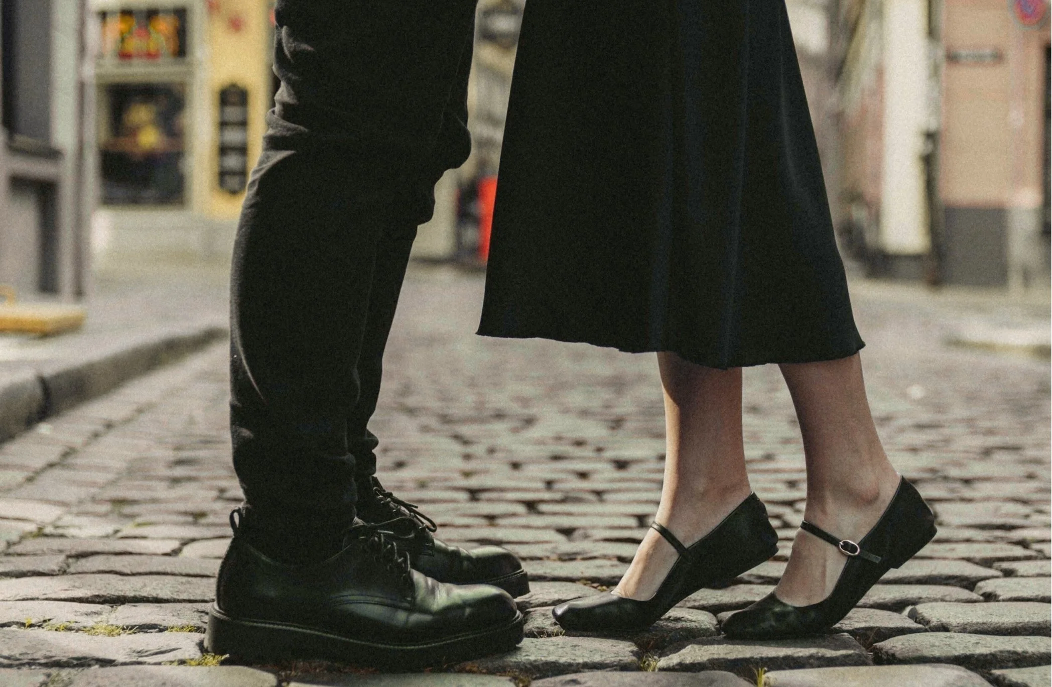 Two partners standing on a cobblestone street,  signifying a relationship bond