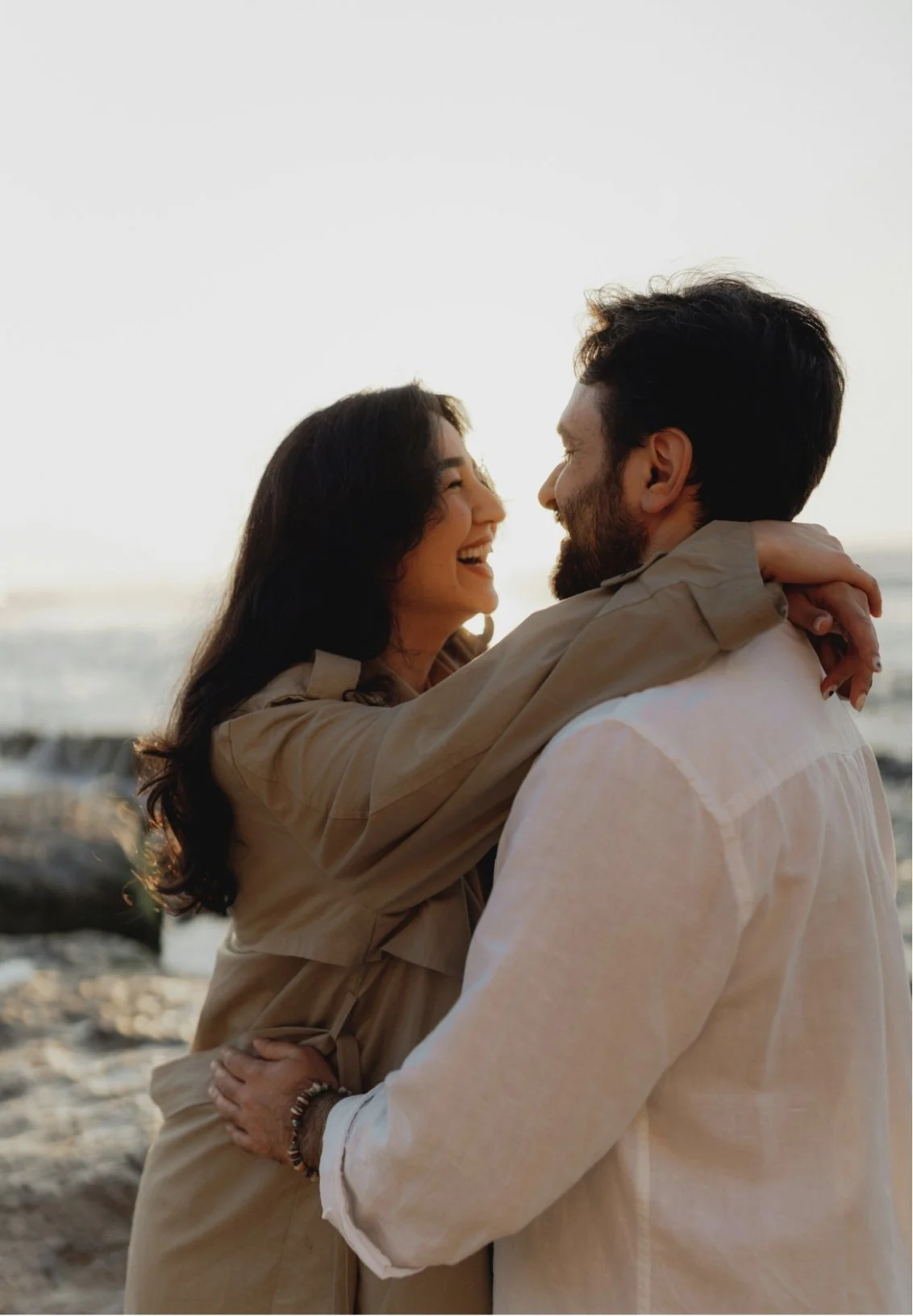 Partners embracing in warm sunset light, their connection strong after couples therapy