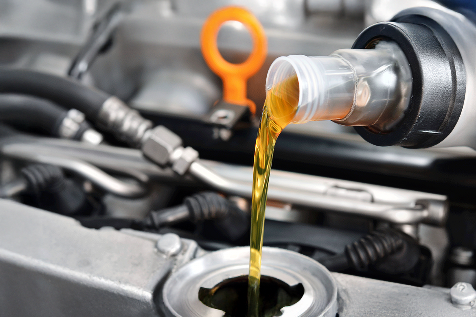 Aerial view of a construction site with several heavy machinery and trucks working on excavating and moving soil, with dirt roads and construction materials visible.