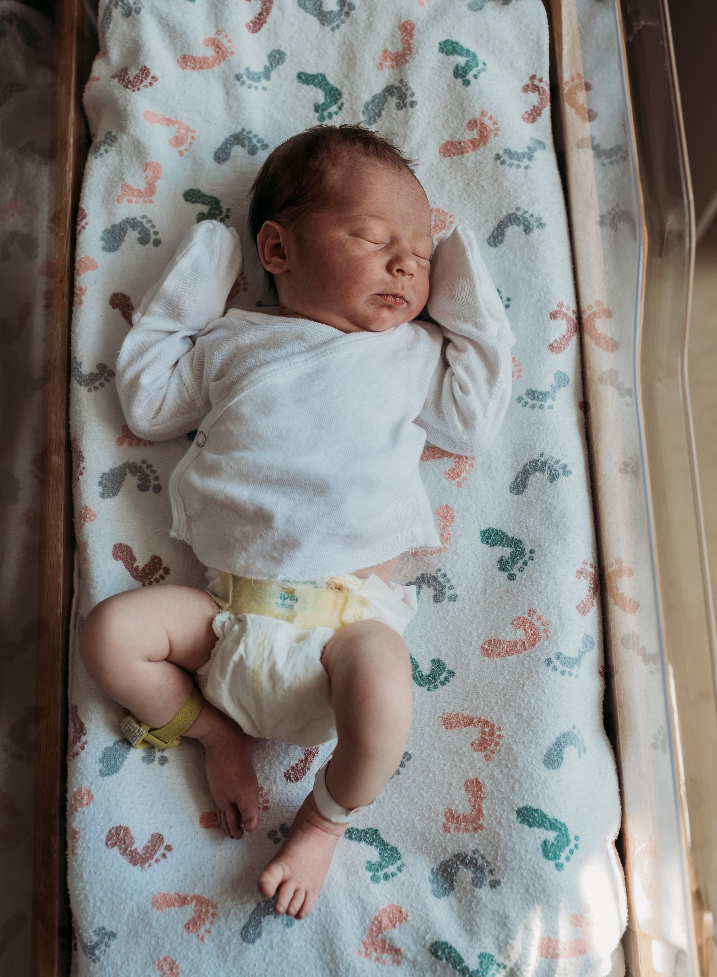 New life: Tiny newborn sleeping soundly in their first hours
