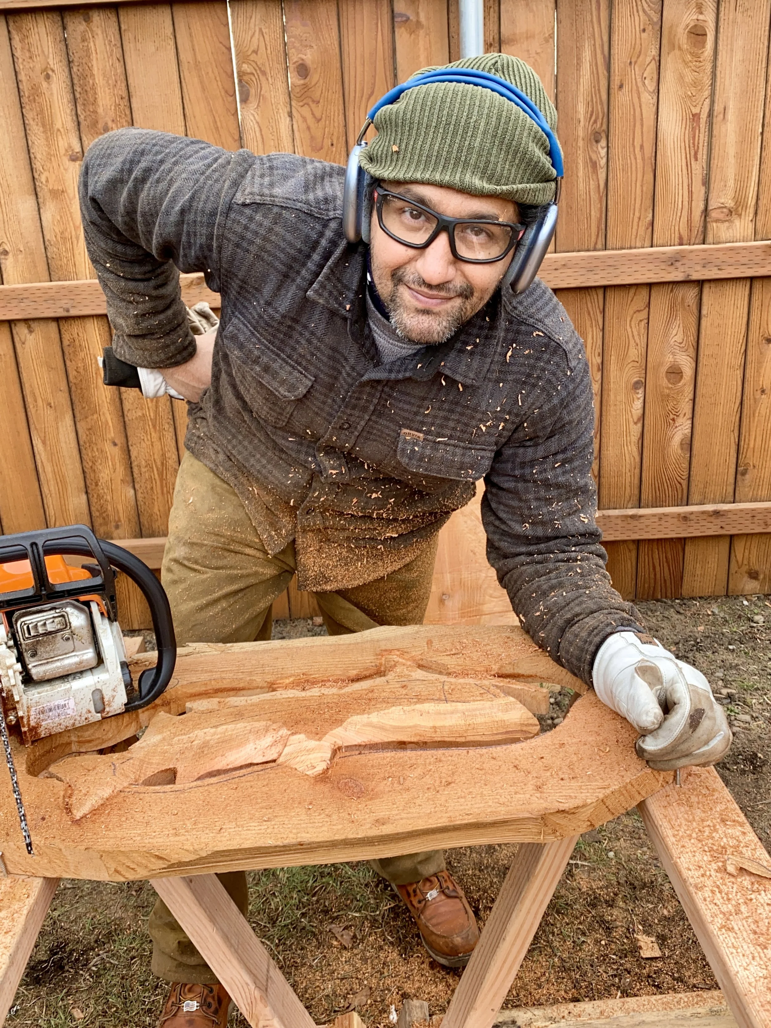 Sawtistic is carving a relief panel of a salmon in a cedar slab