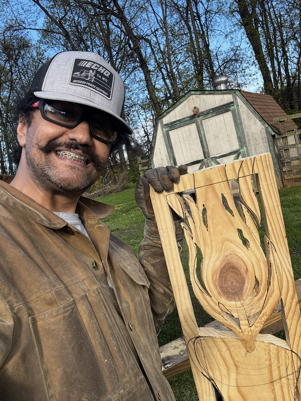 Sawtistic is holding an in-progress relief carving of a candle flame