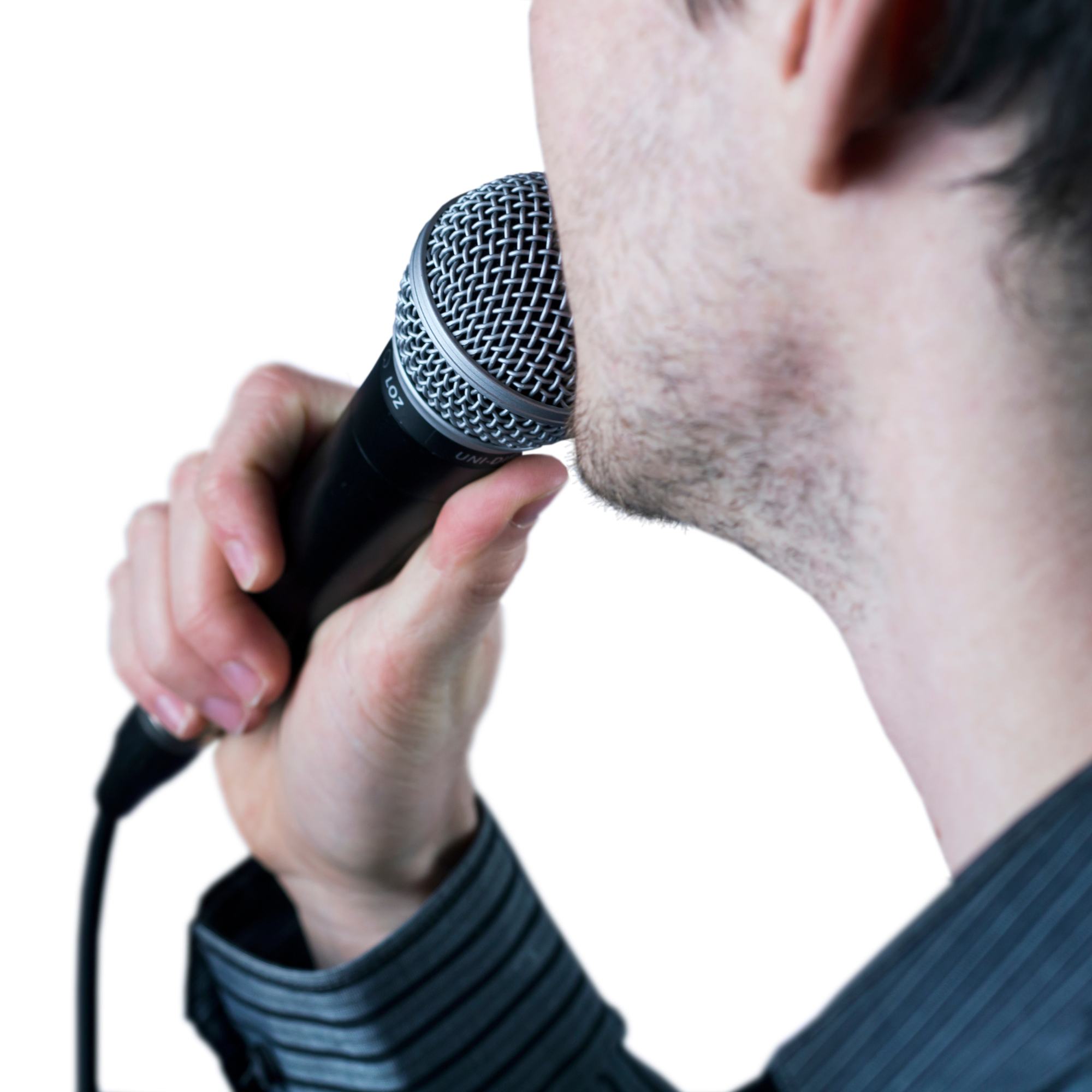 Close-up of a person holding a microphone near their mouth, preparing to speak or sing.