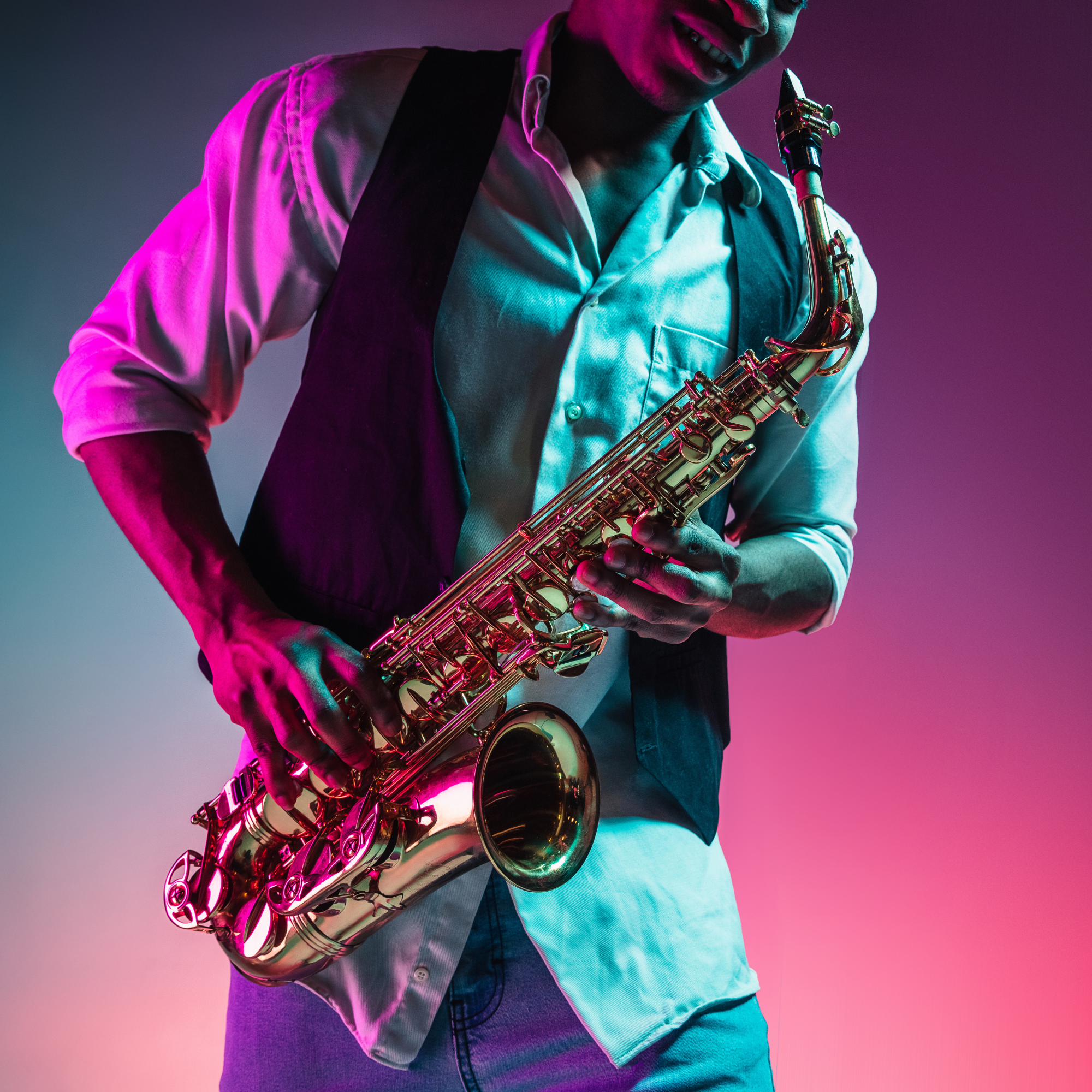 A person playing a gold saxophone, wearing a white shirt and black vest, with colorful lighting.