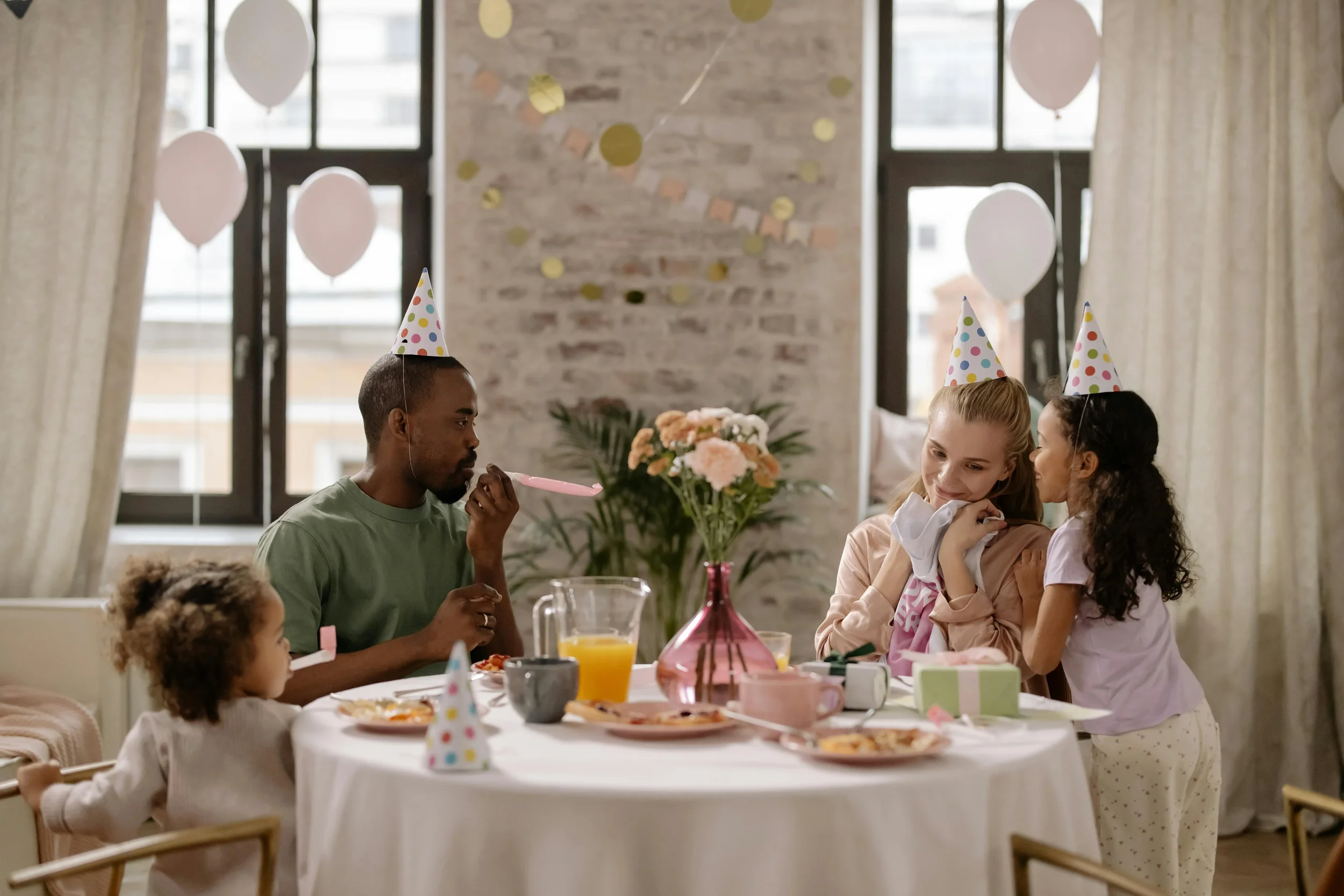 family sitting at a table celebrating a birthday