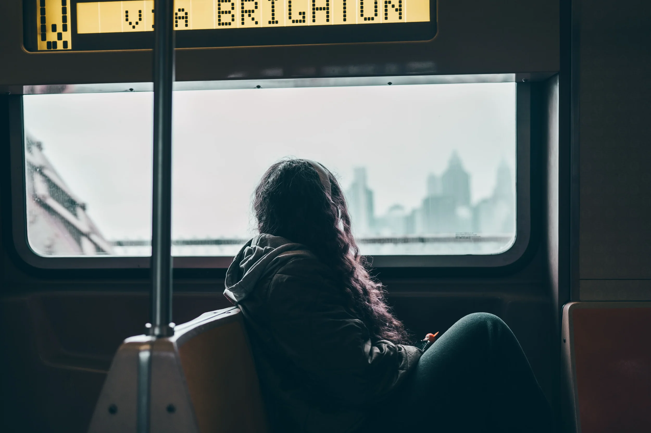 woman looking out of the window on the subway