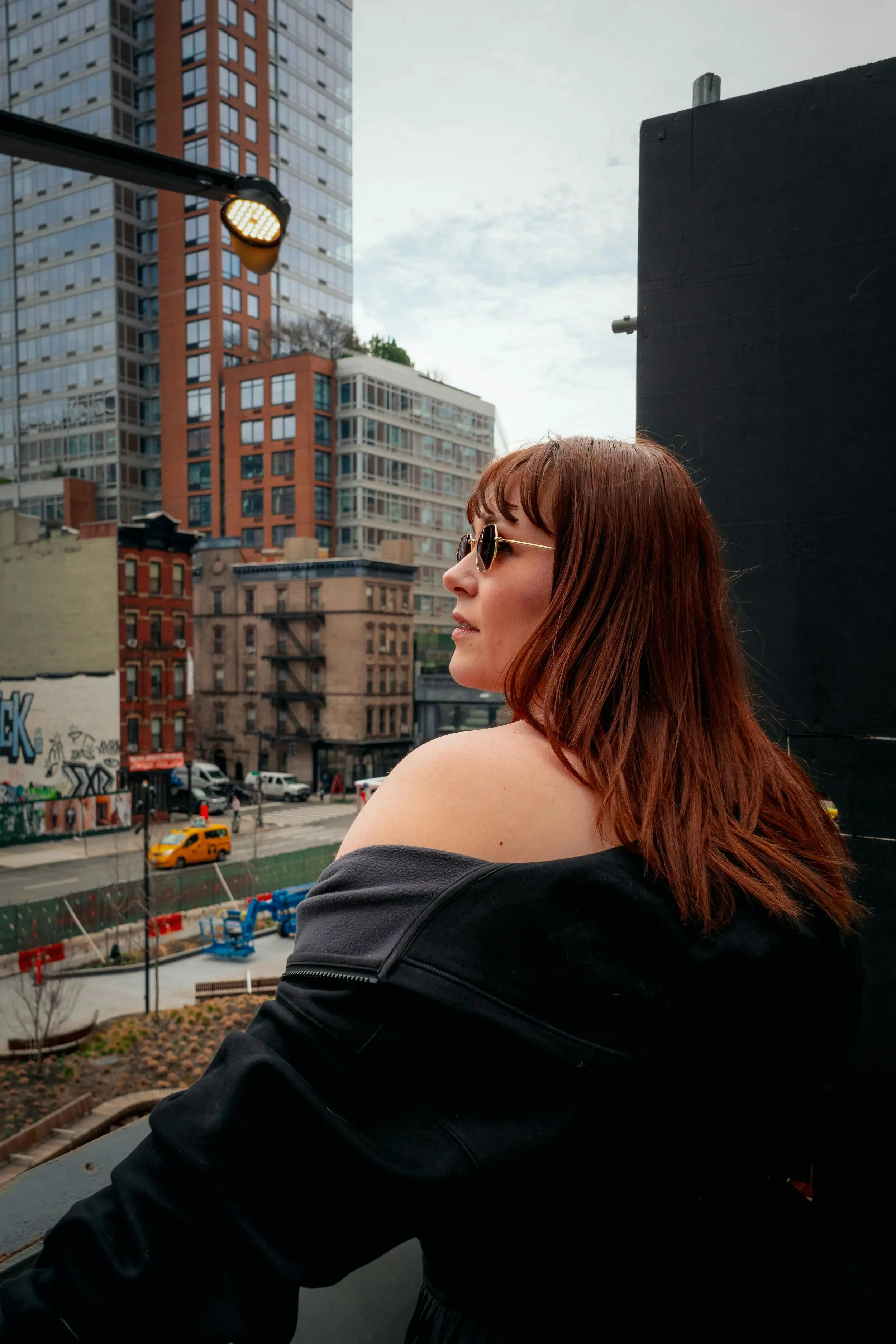 Woman outside looking out into the NYC streets.