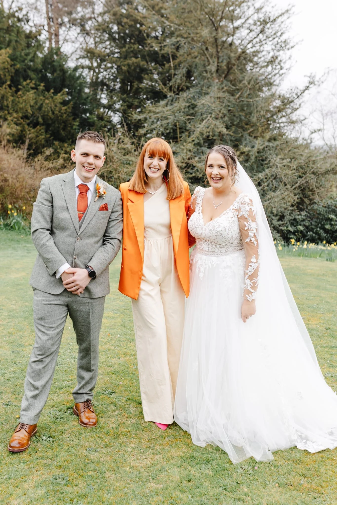 A bride and groom are dancing closely, smiling happily, surrounded by falling red heart-shaped confetti at their wedding reception.