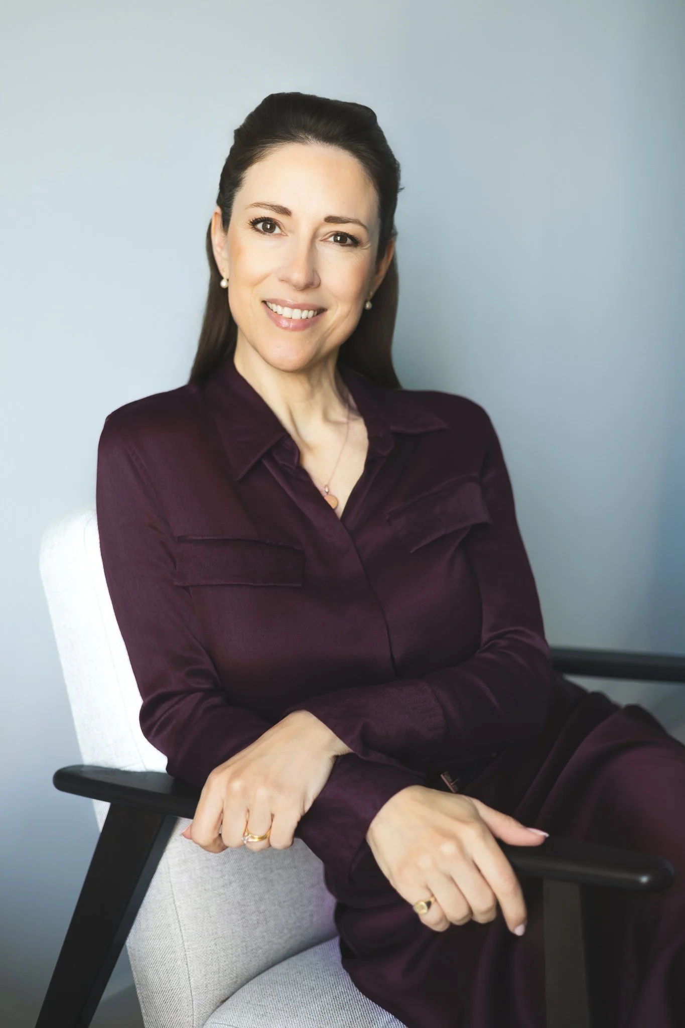 Portrait in burgundy blouse with arms folded | Edge & Grace