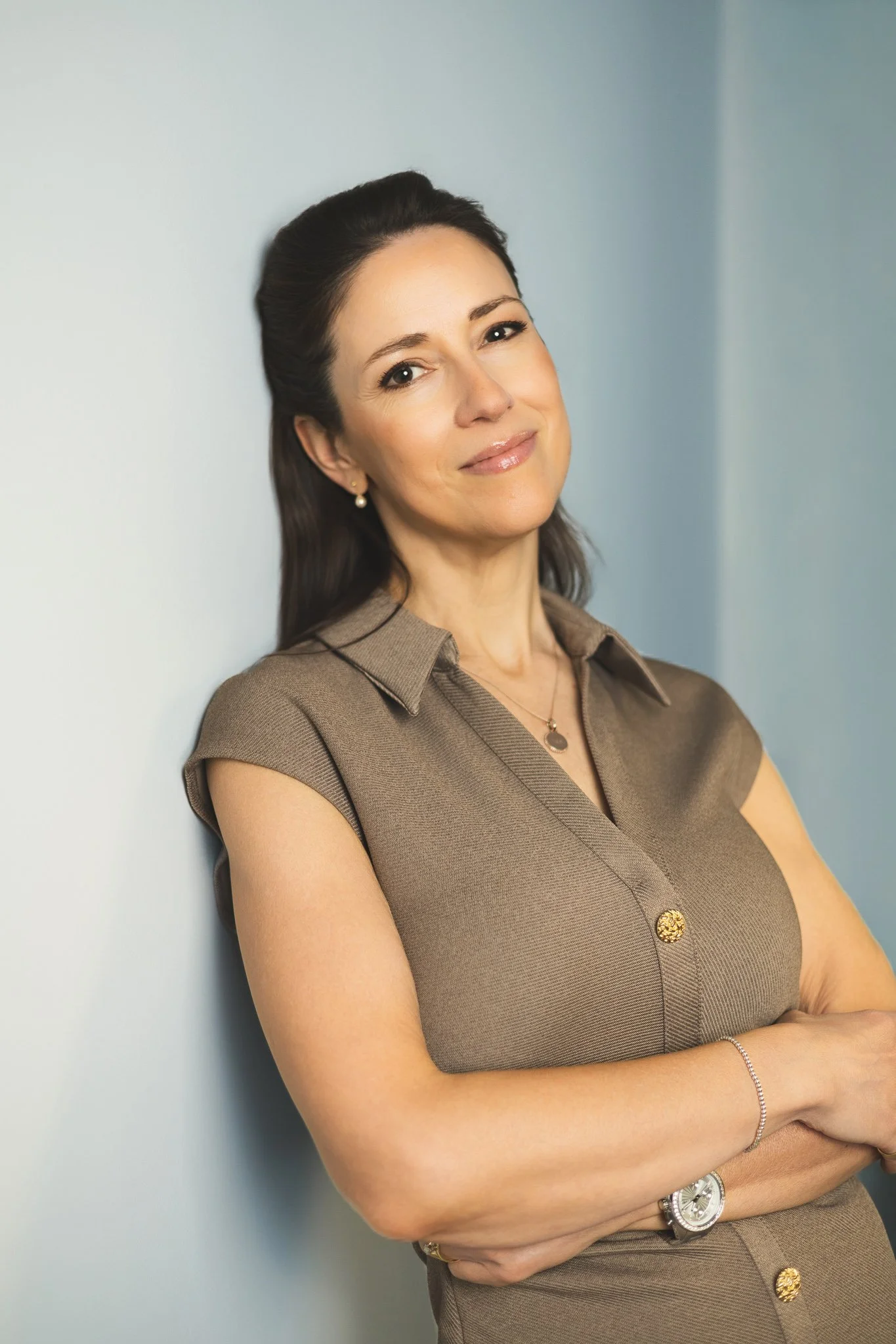 Portrait in patterned top against blue wall | Edge & Grace