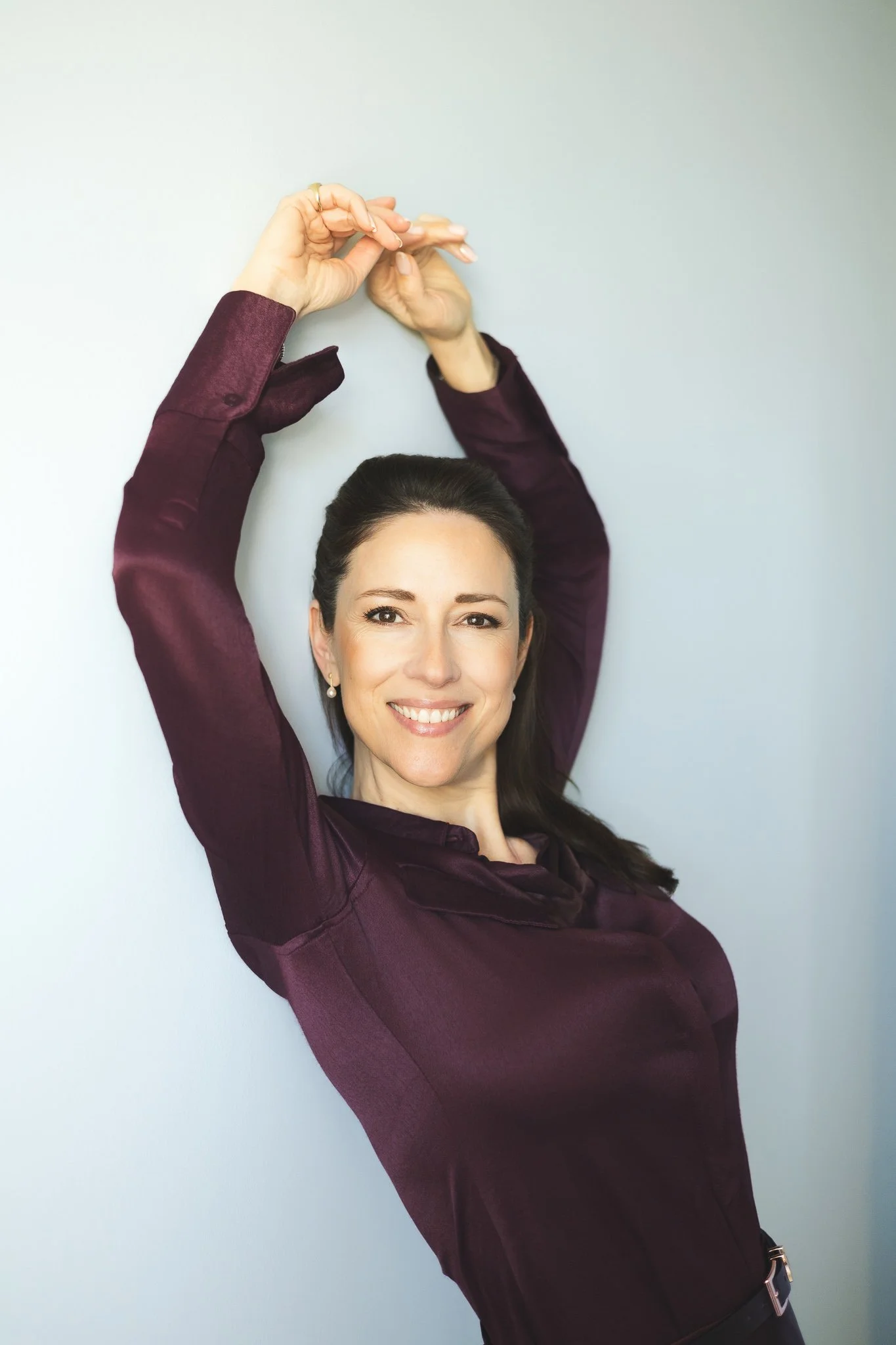 Portrait in burgundy with raised arm | Edge & Grace