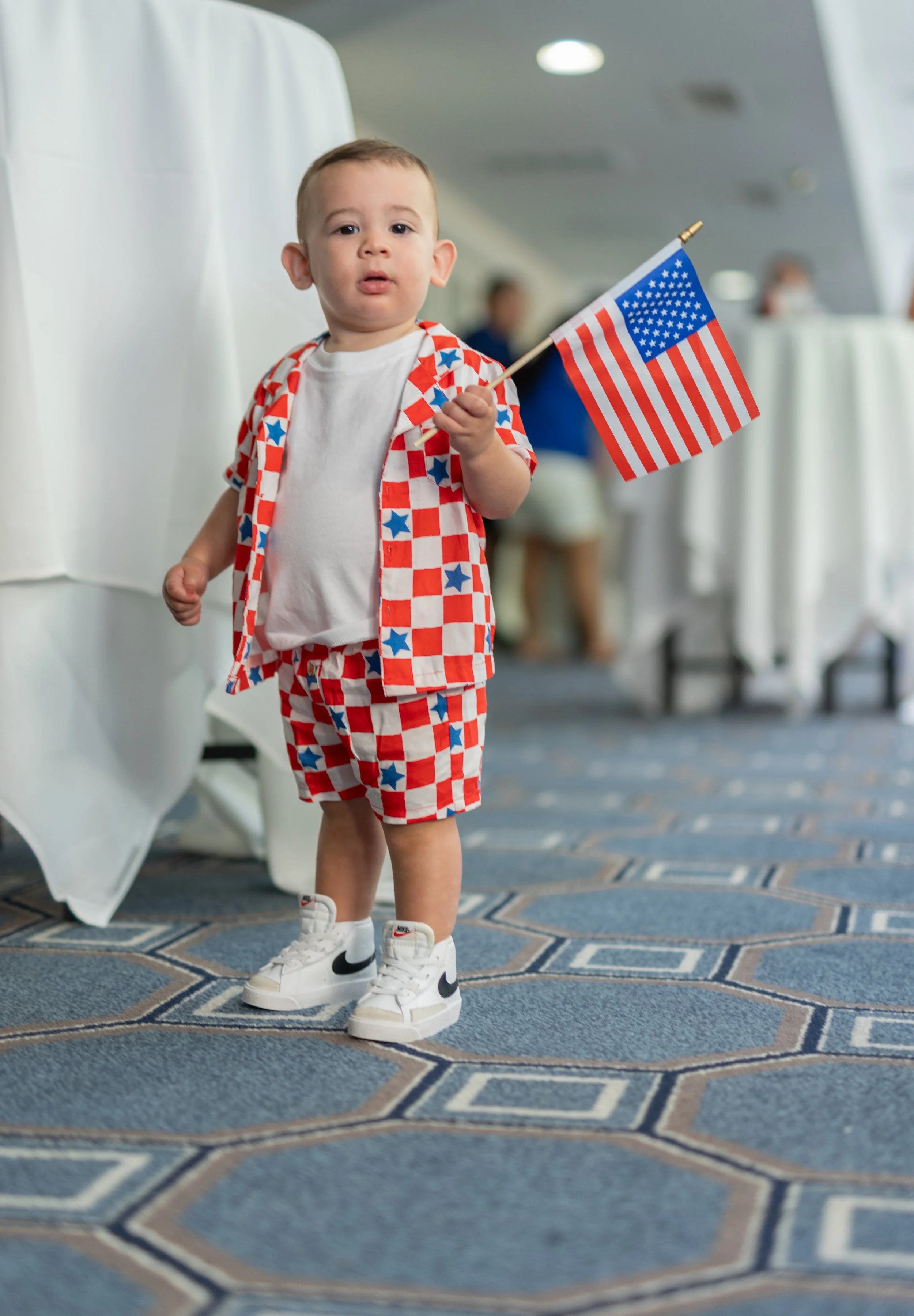 Young boy at 2024 Stars & Stripes on Houston Street watch party.