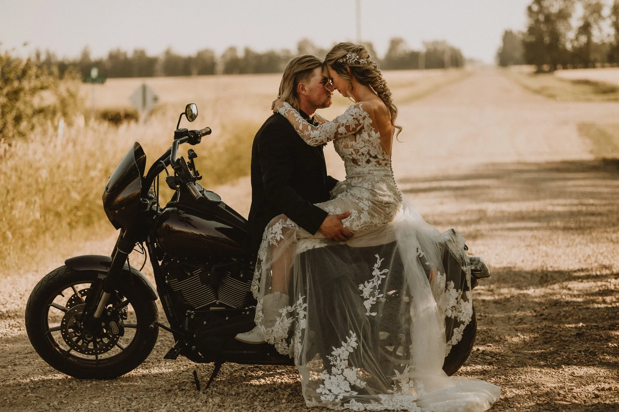 Couple sharing a kiss on a motorcycle during their intimate Edmonton, Alberta elopement, photographed by Calgary & Alberta elopement photographer Shannon Boyd