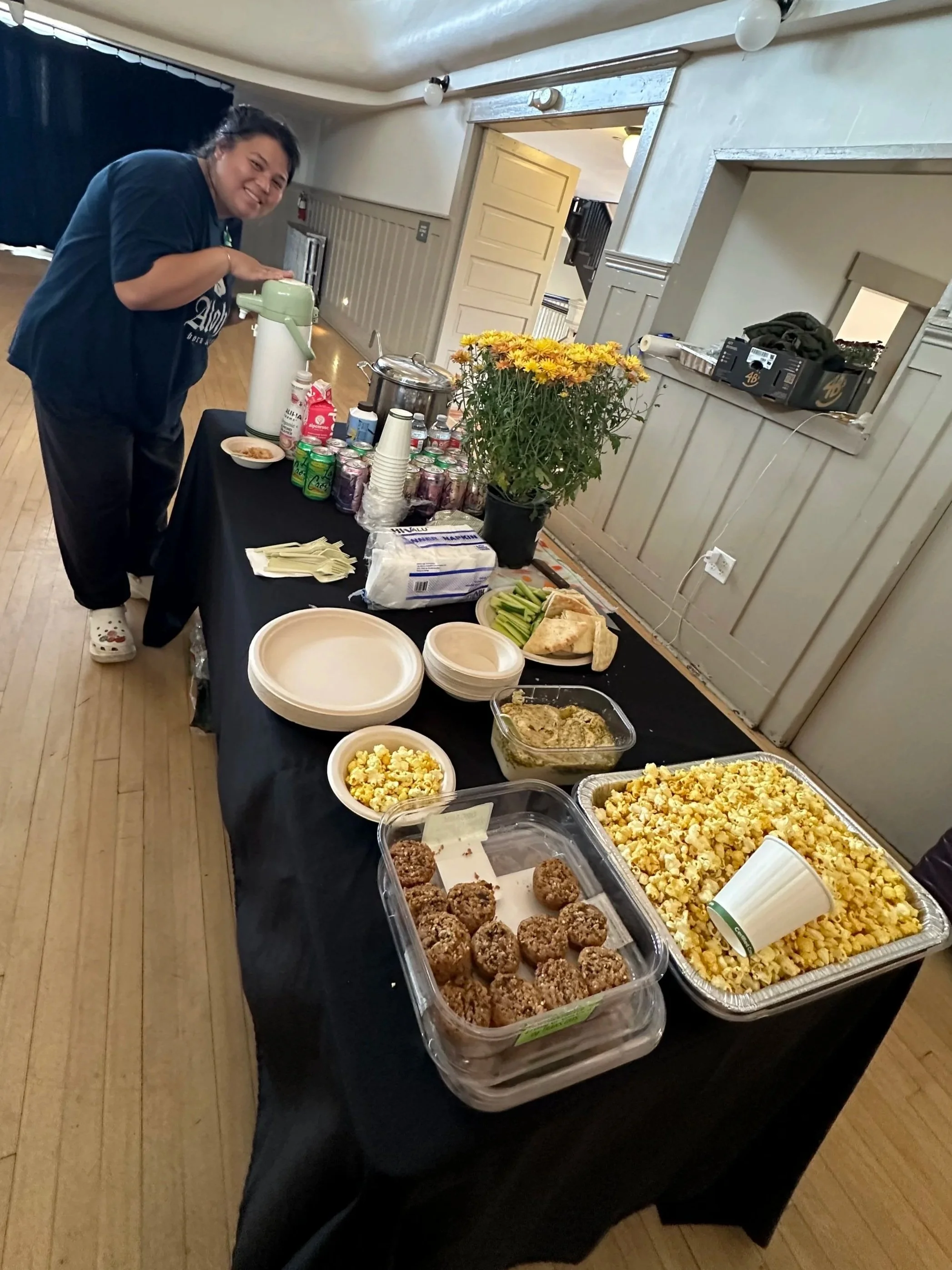 Community member celebrating with food at a Voices Rising Workshop