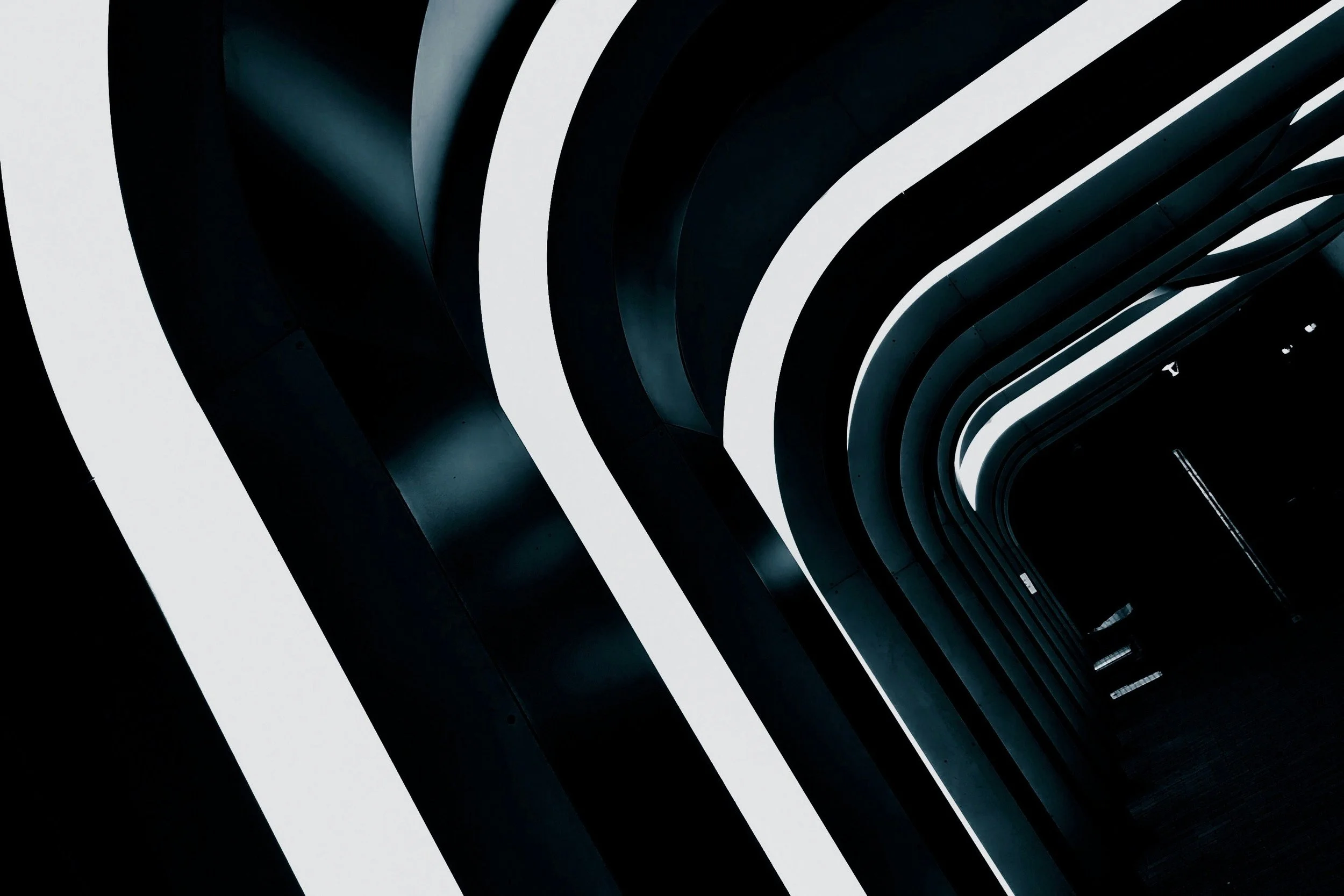 Interior architecture with black and white curving hallway and futuristic design.