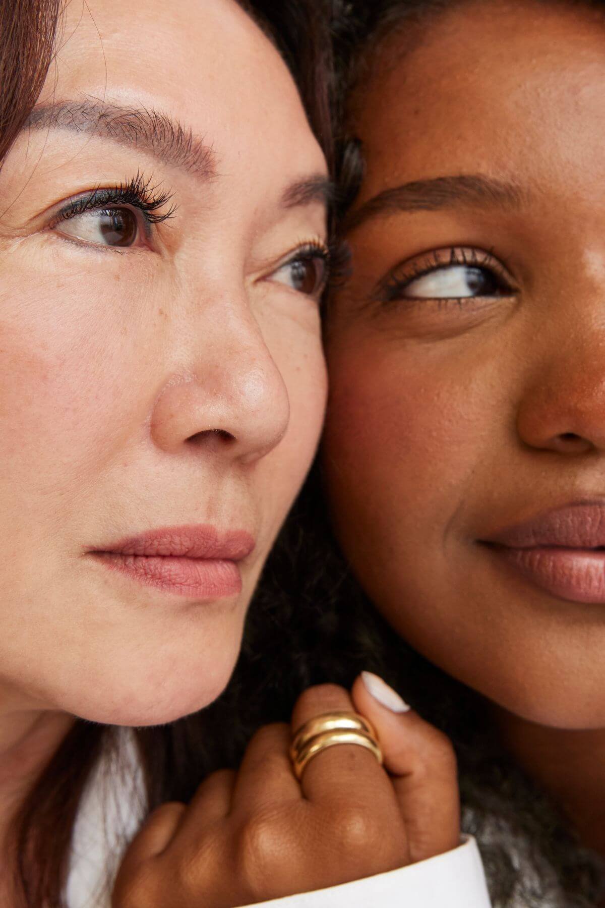 Two women's faces side-by-side and looking away posed for a photo for Clemens Face + Body, a boutique medspa in Brookline