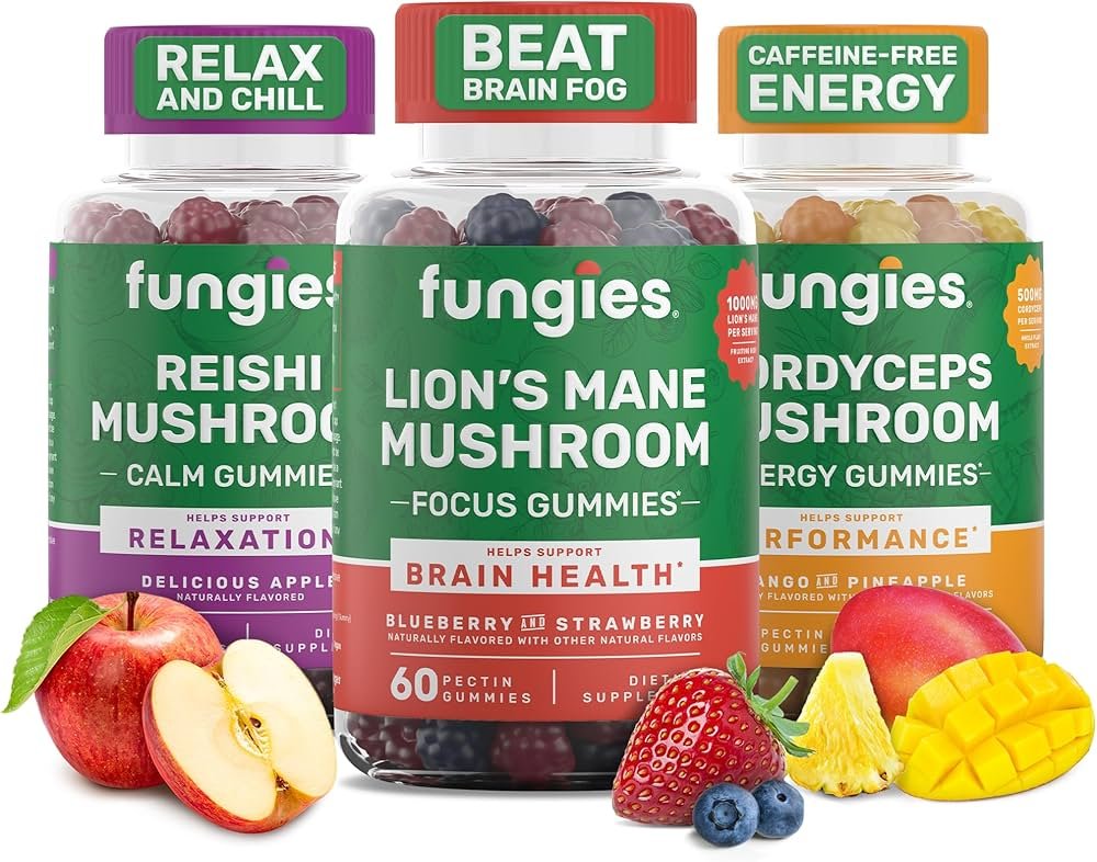 Three bottles of Fungies gummy vitamins with different labels and flavors: Reishi Mushroom Calm Gummy, Lion's Mane Mushroom Focus Gummy, and Cordyceps Mushroom Energy Gummy, surrounded by apples, strawberries, blueberries, pineapple, and mango.