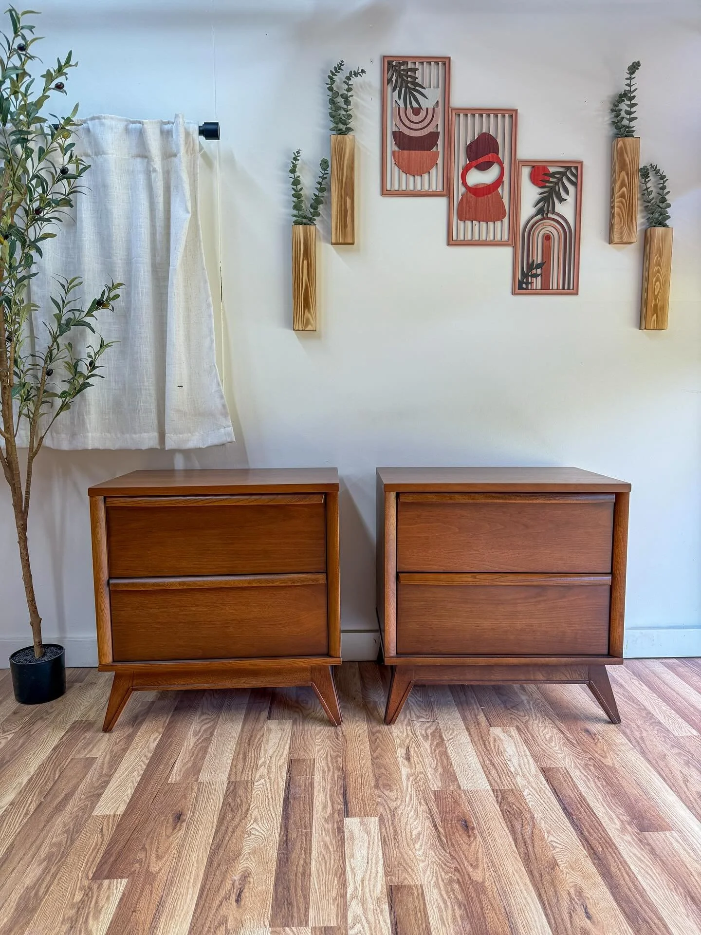 (SOLD) Mid century modern MCM vintage walnut two-drawer nightstands by Unagusta for their Distinctive line. Circa 1960&rsquo;s. Two full sized dove-tailed drawers all slide great on both. Solid walnut drawer pulls. Classic sleek slanted mid century l