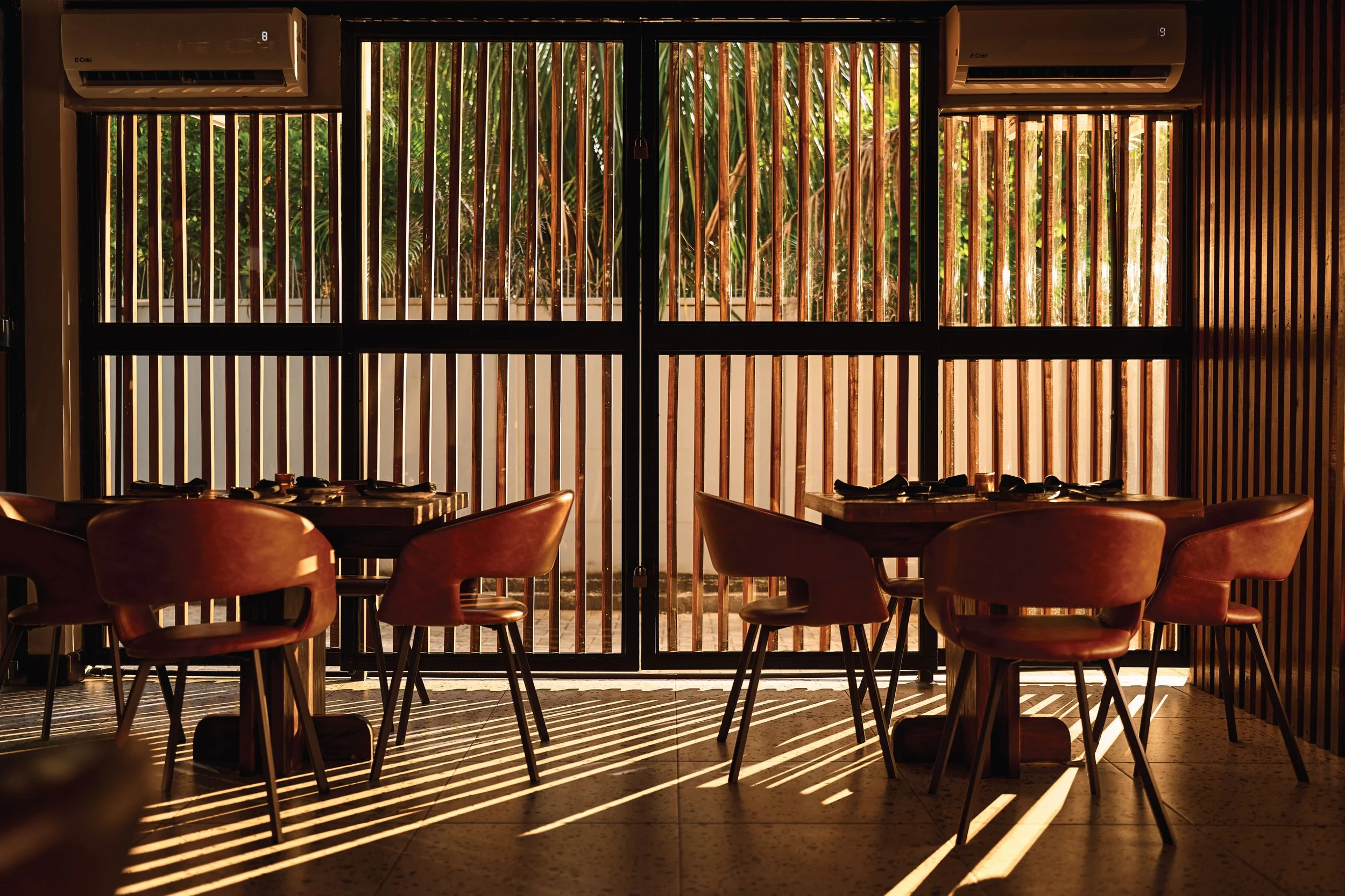 Timber slat screens filtering daylight onto the dining room, Satori